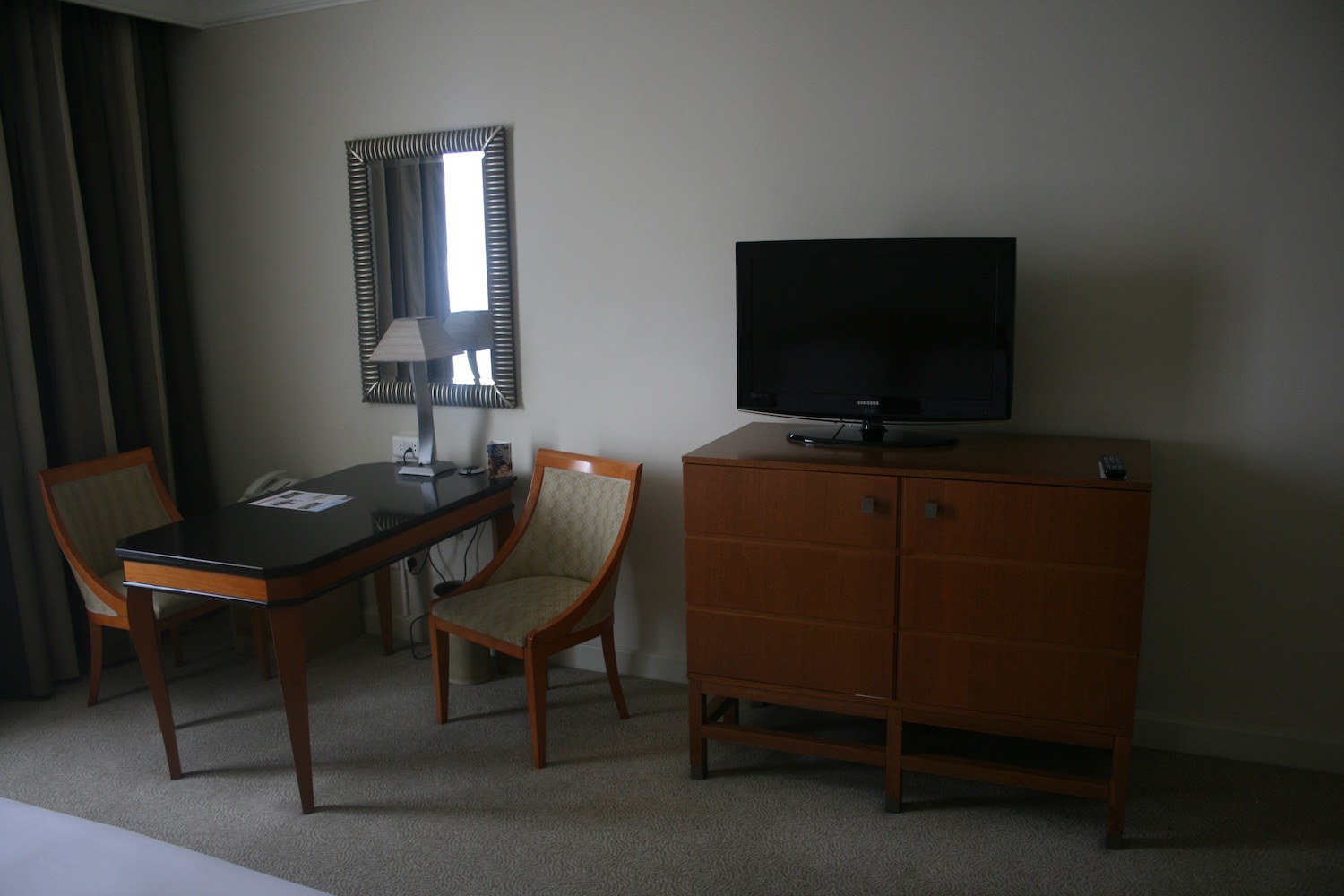 a room with a television and a desk