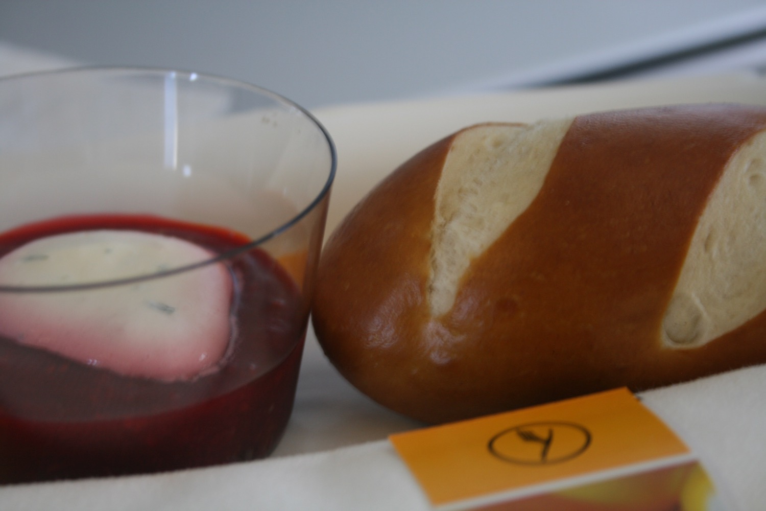 a loaf of bread next to a glass of red liquid
