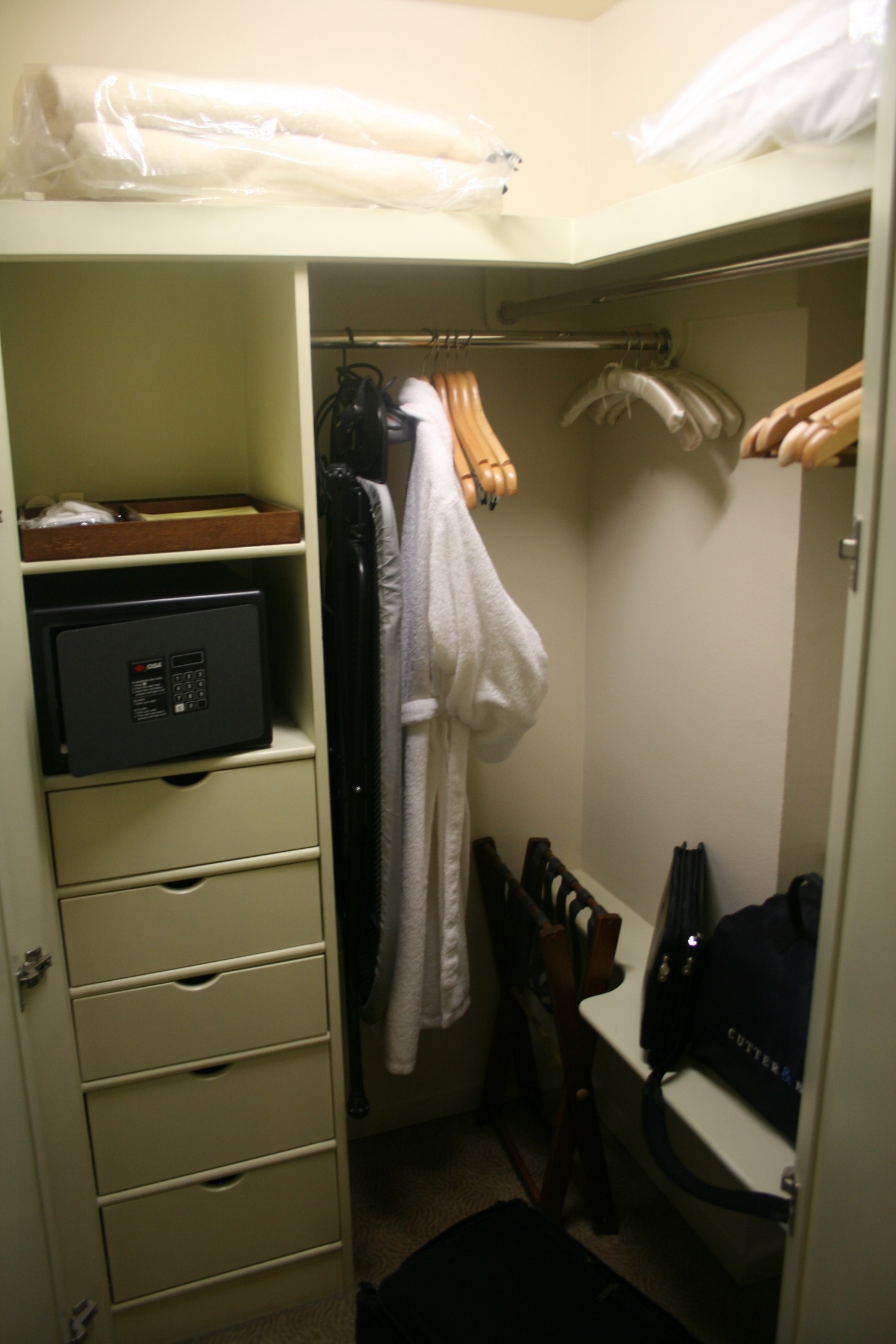 a closet with white robe and swingers