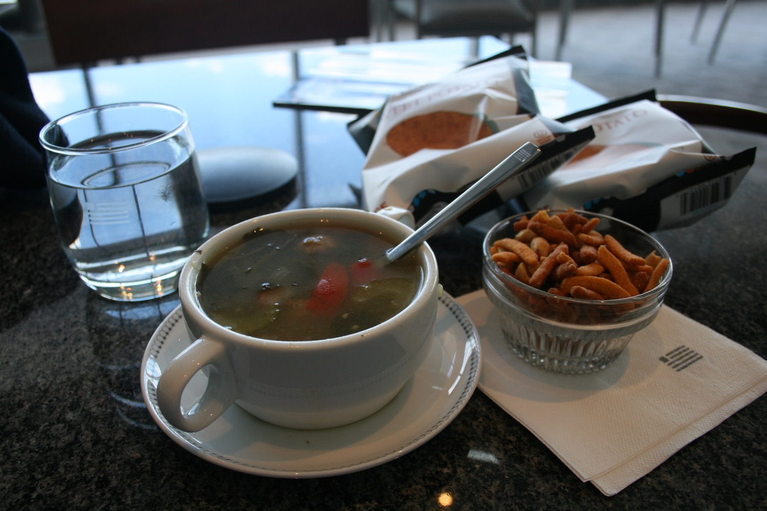 a bowl of soup and a bowl of pretzels on a table