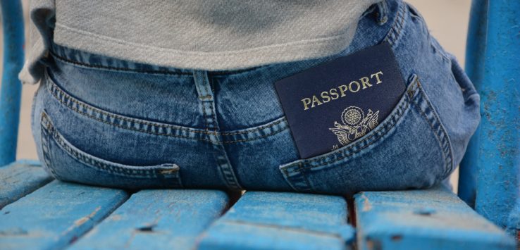 a passport in the back pocket of a person's jeans