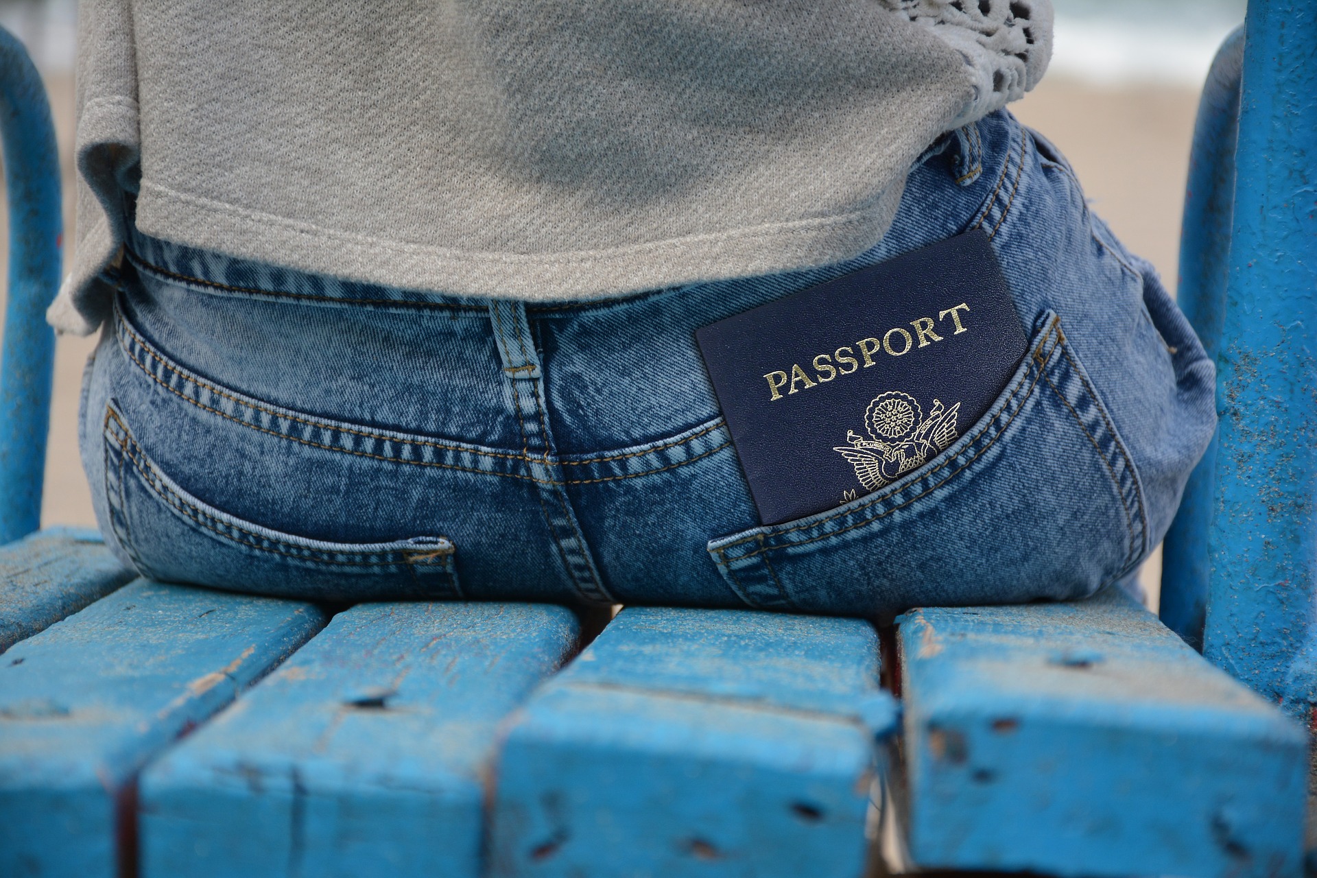 a passport in the back pocket of a person's jeans