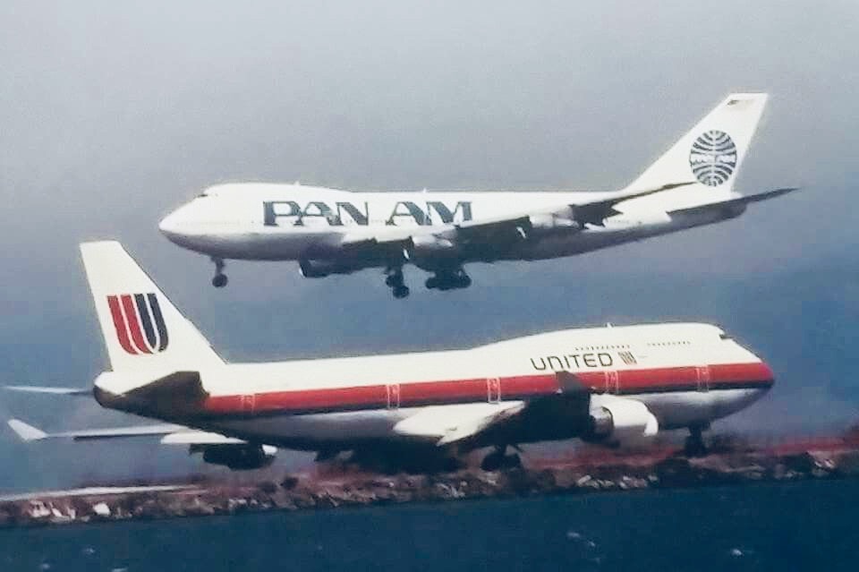 two airplanes flying over water