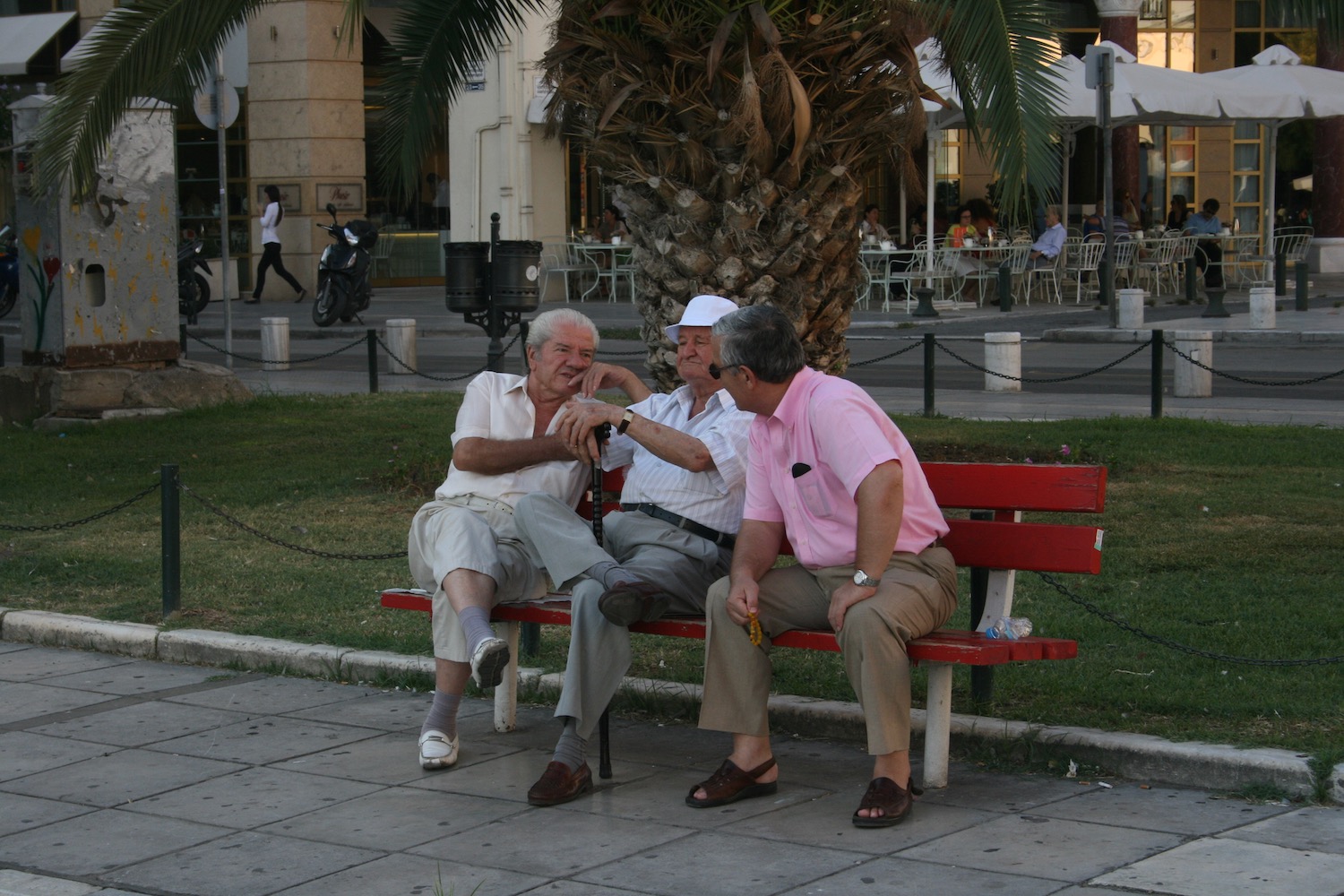 a group of men sitting on a bench