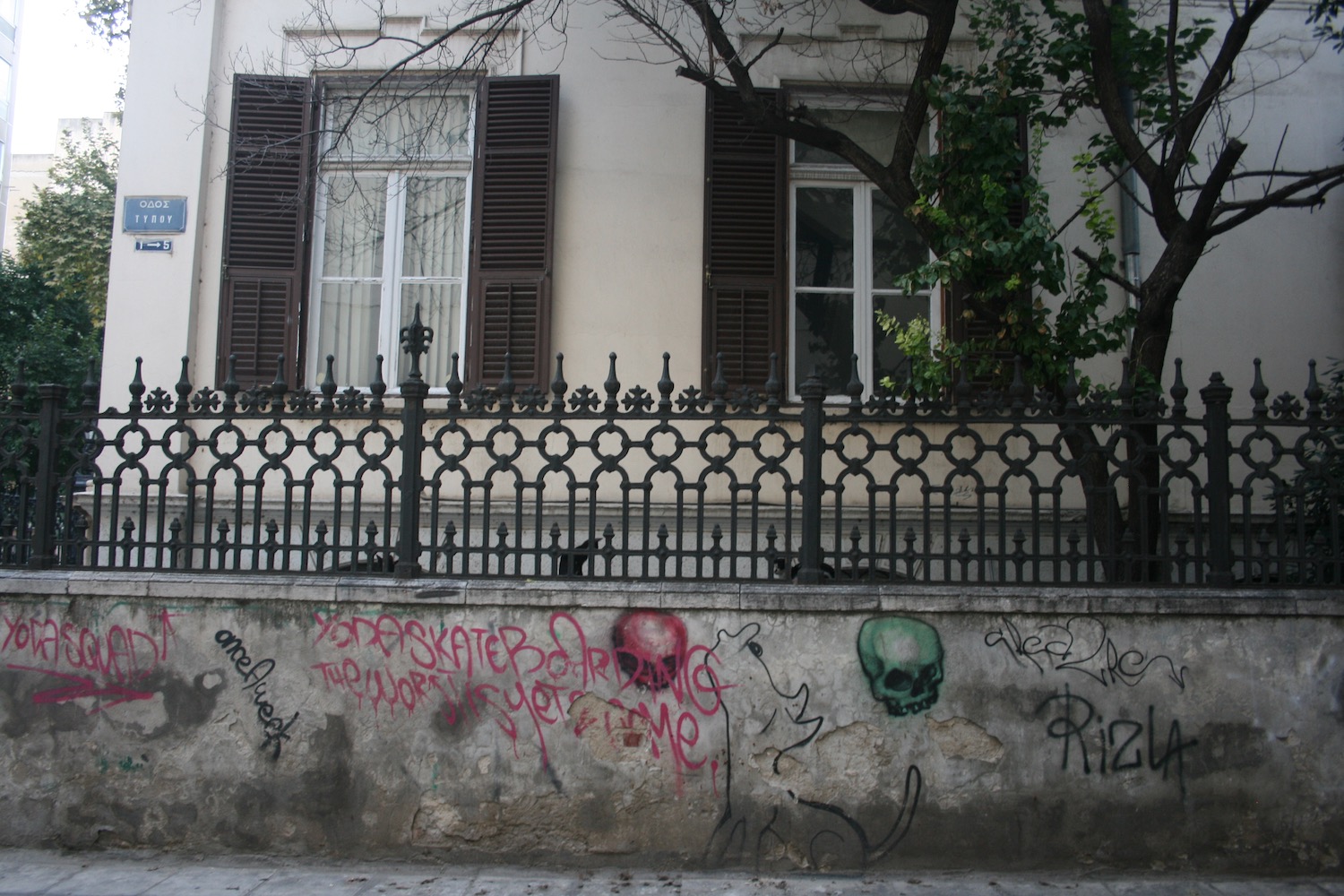a building with a fence and graffiti