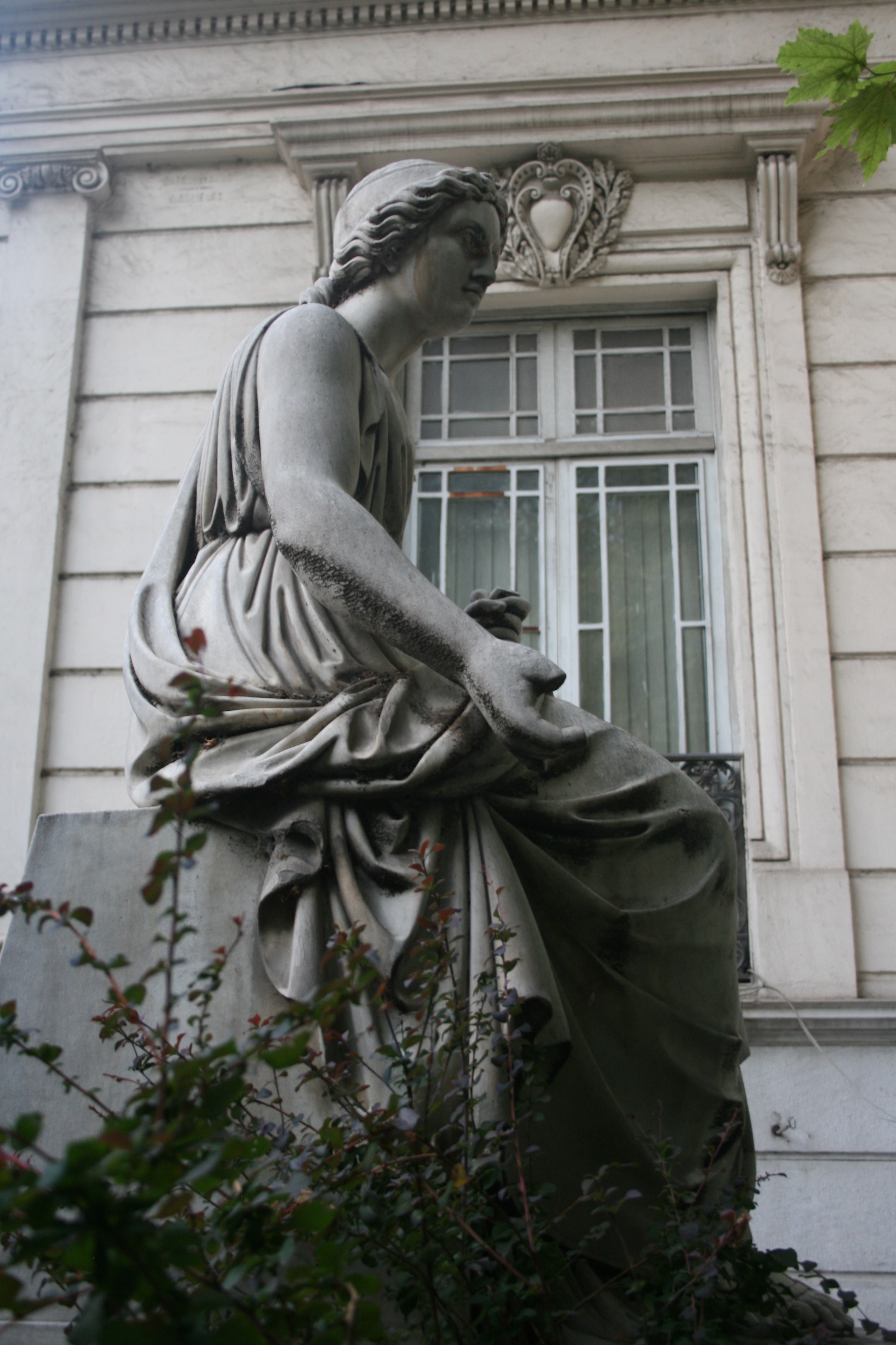 a statue of a woman sitting on a pedestal
