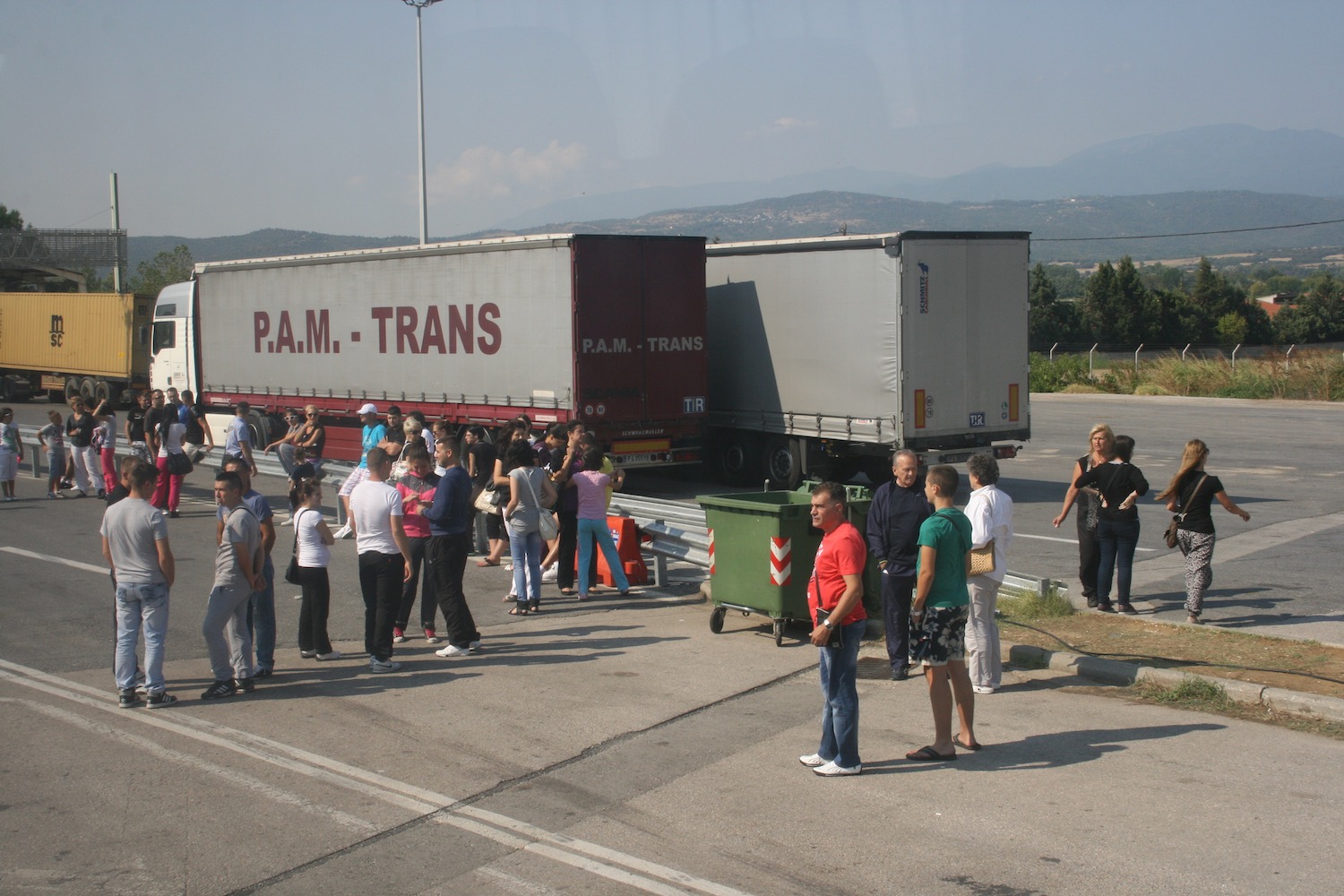 a group of people standing next to a truck