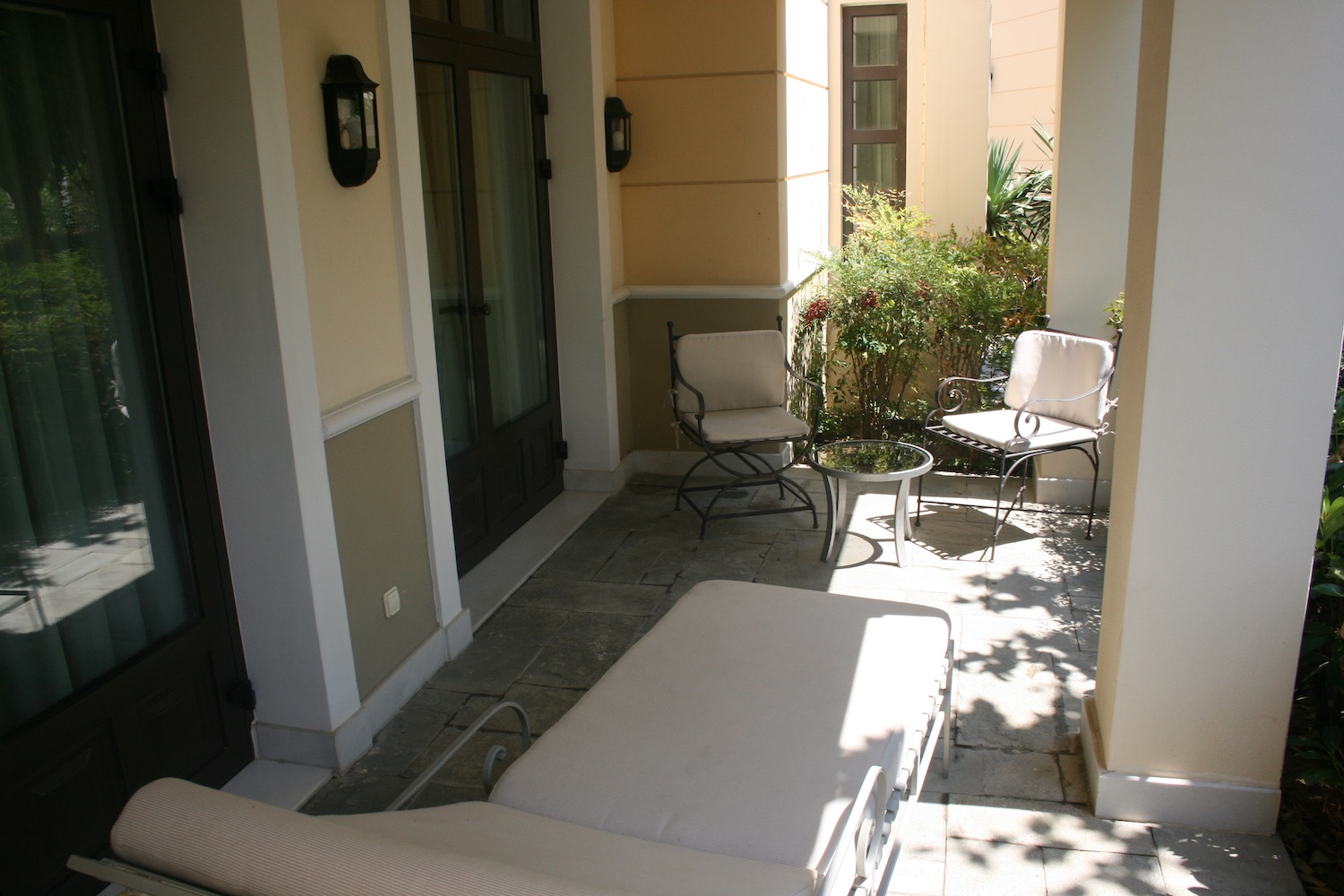 a patio with chairs and a table