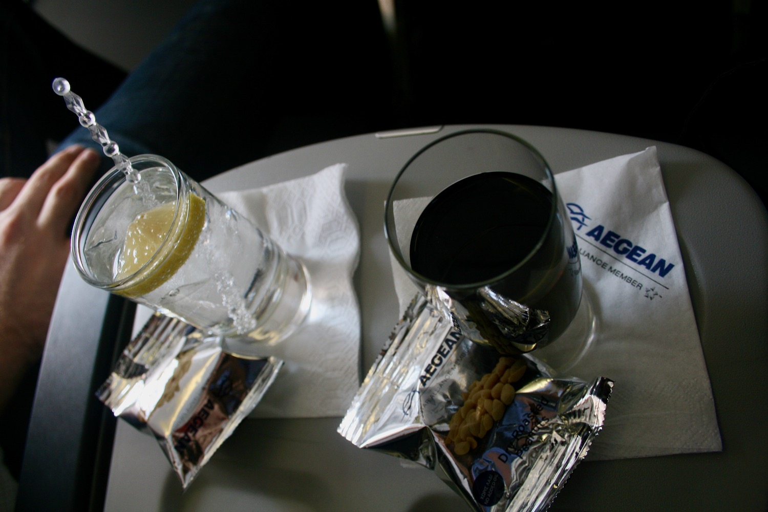 a glass of water and a lemon on a table