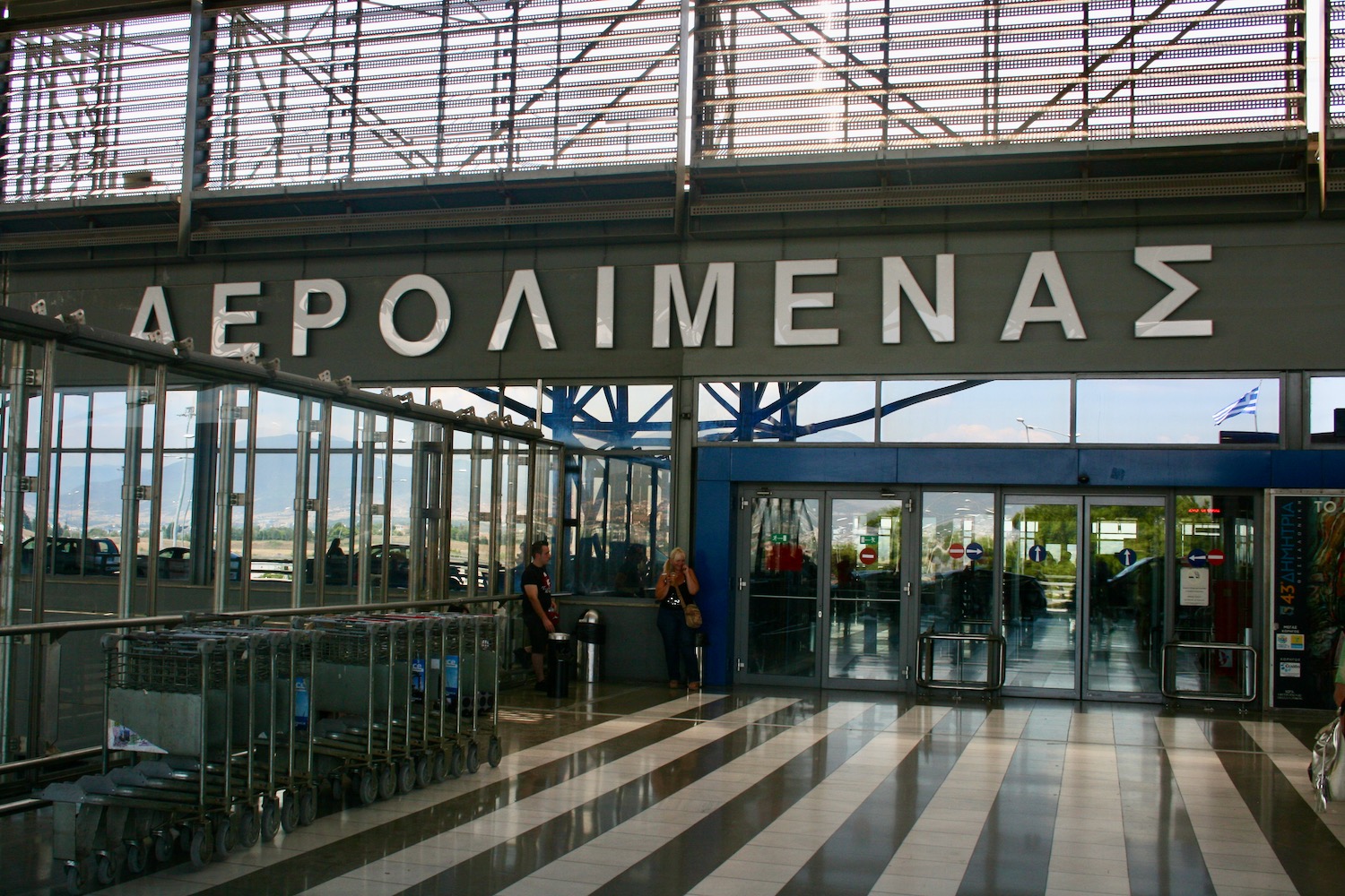 a large glass entrance with a sign