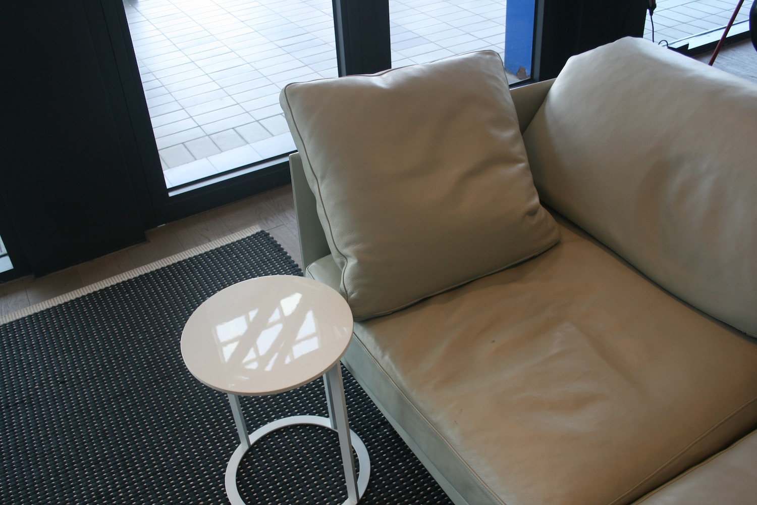 a white couch with a small round table