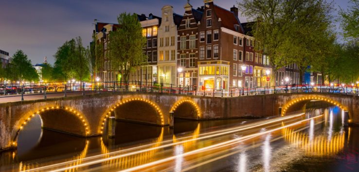 a bridge over a river with lights on it