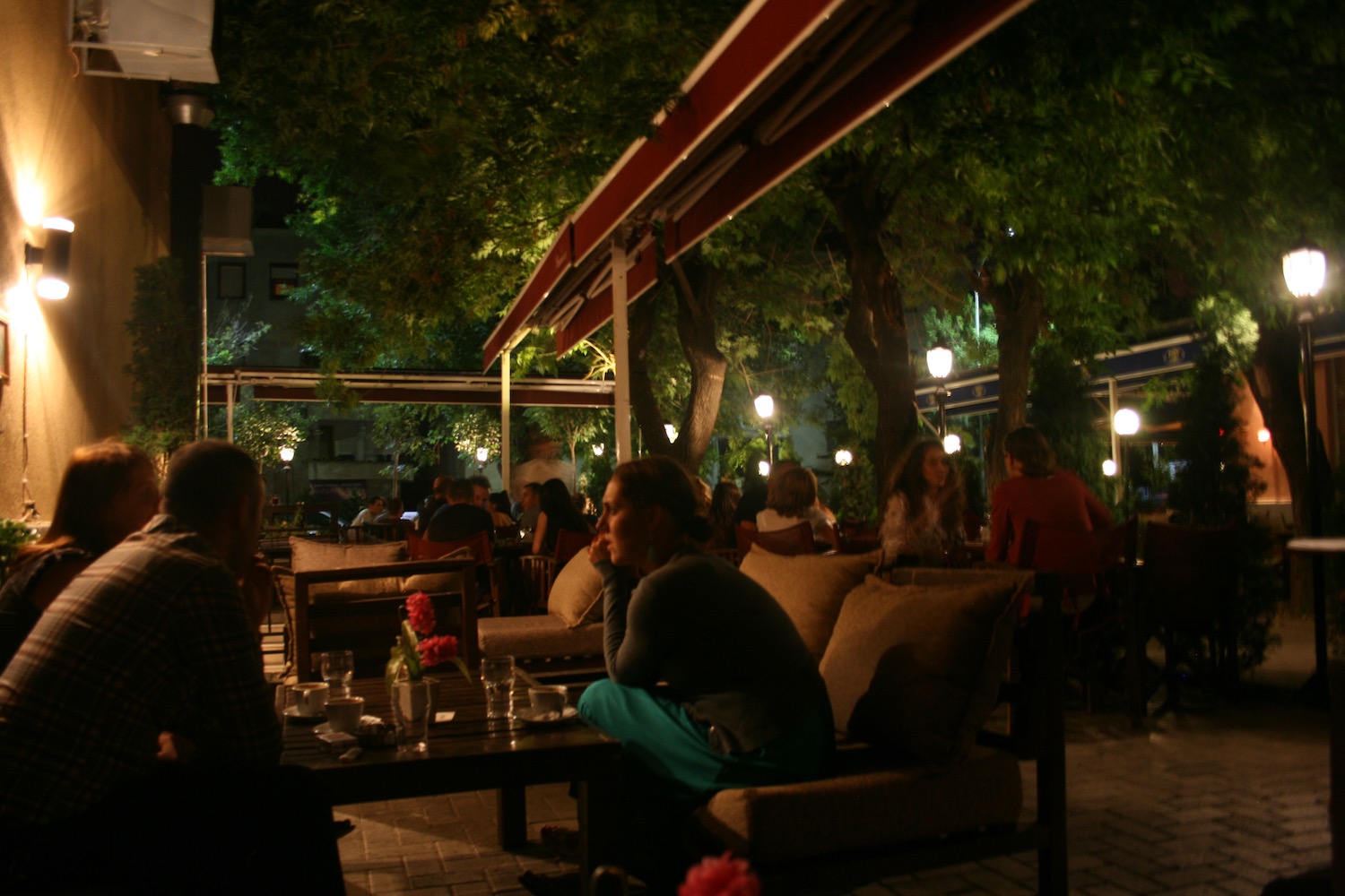 people sitting at a table outside at night