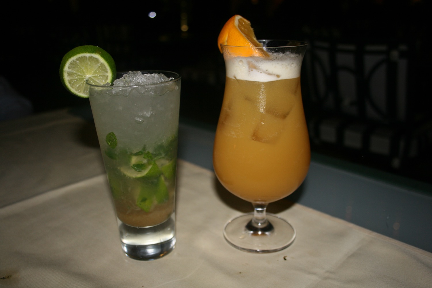 two glasses with drinks on a table