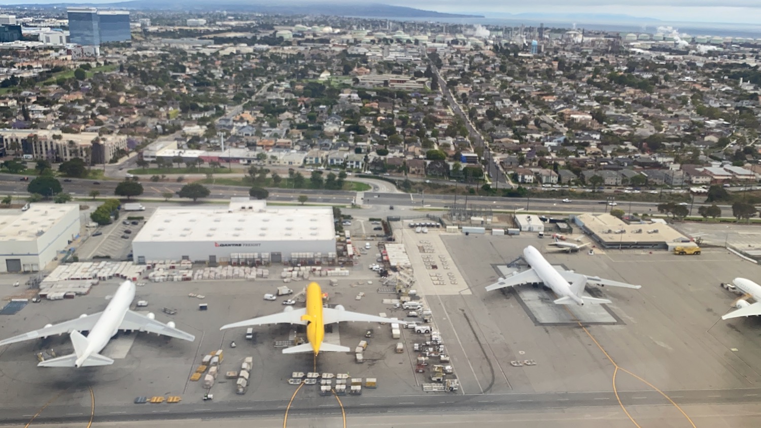 an aerial view of airplanes on a runway