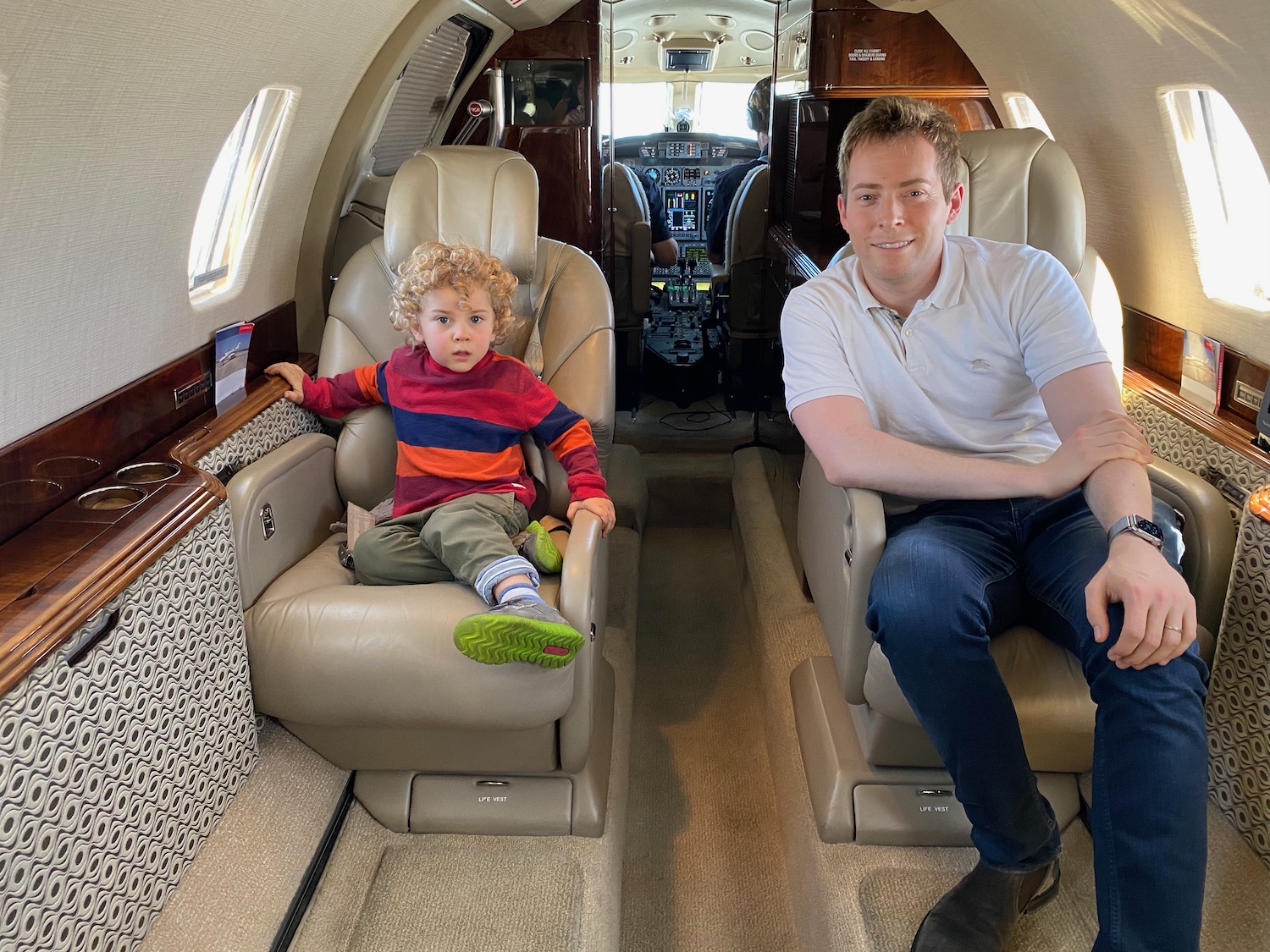 a man and child sitting in a plane