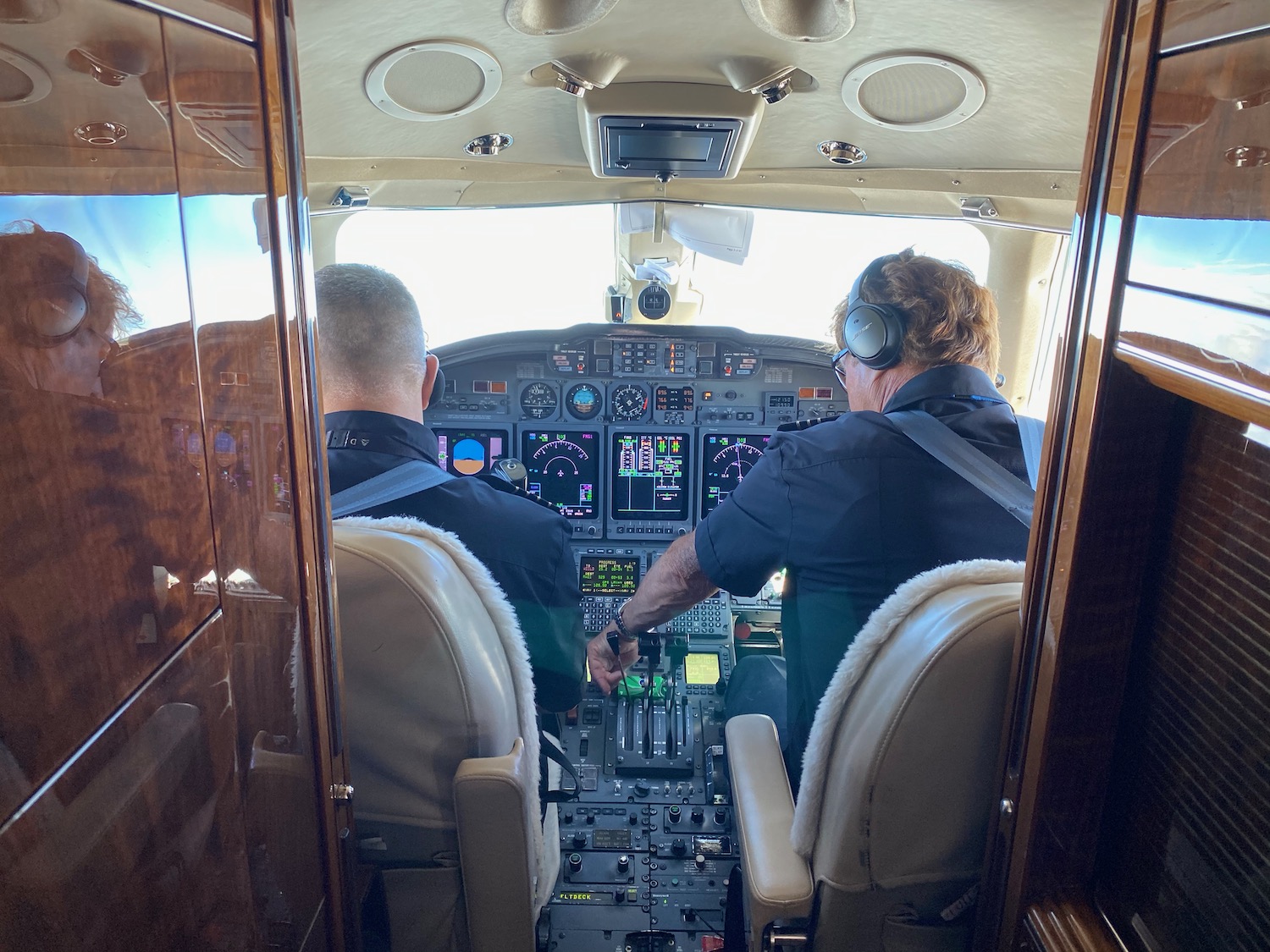 a group of men in the cockpit of an airplane