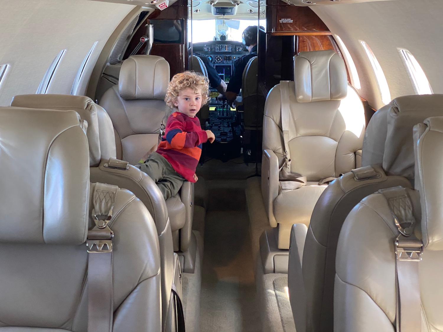 a child sitting on the back of an airplane