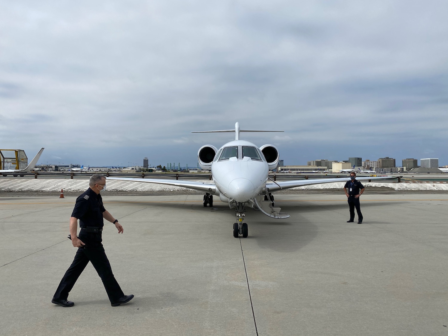 a man walking next to a plane