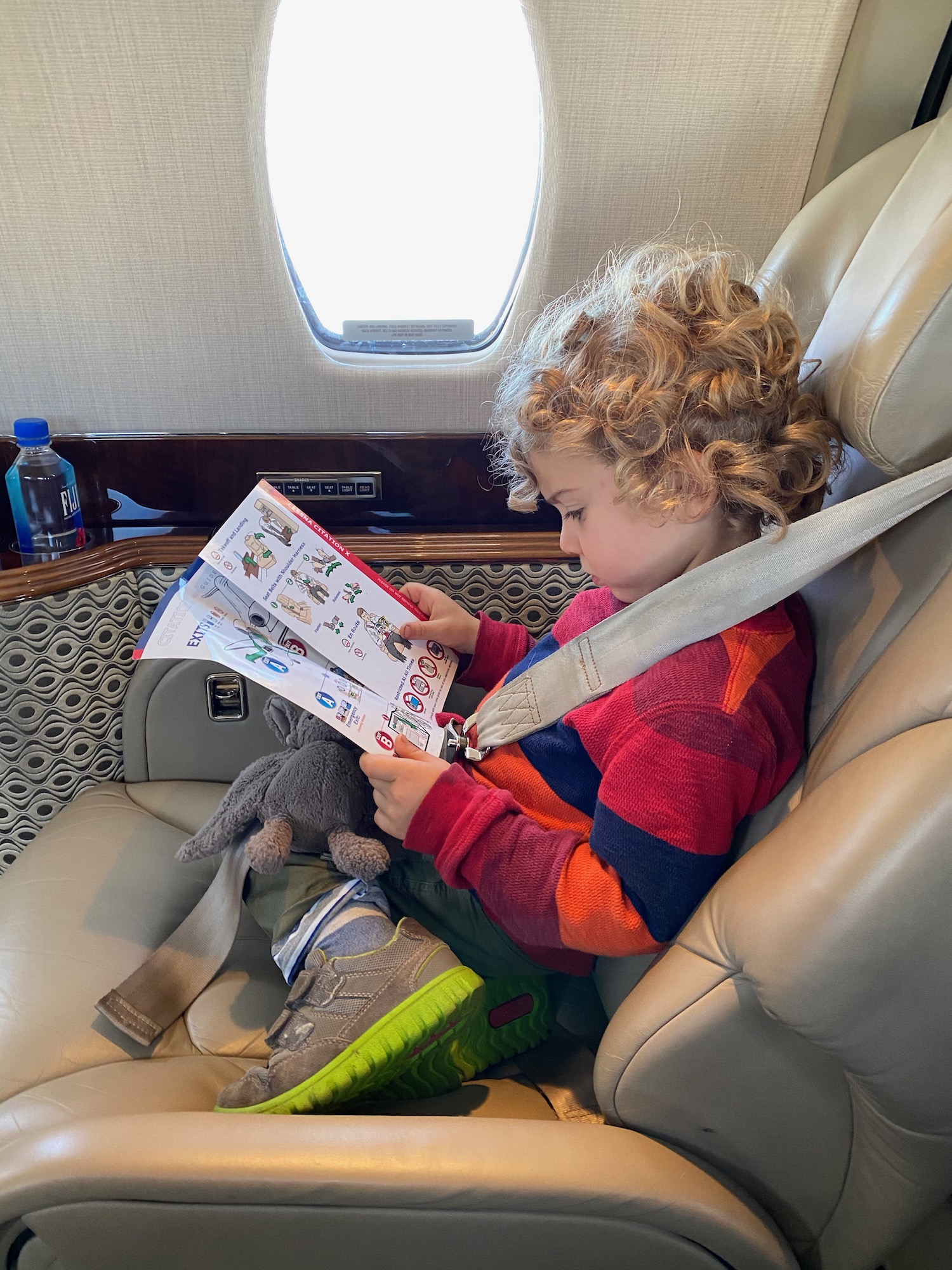 a child reading a book on an airplane