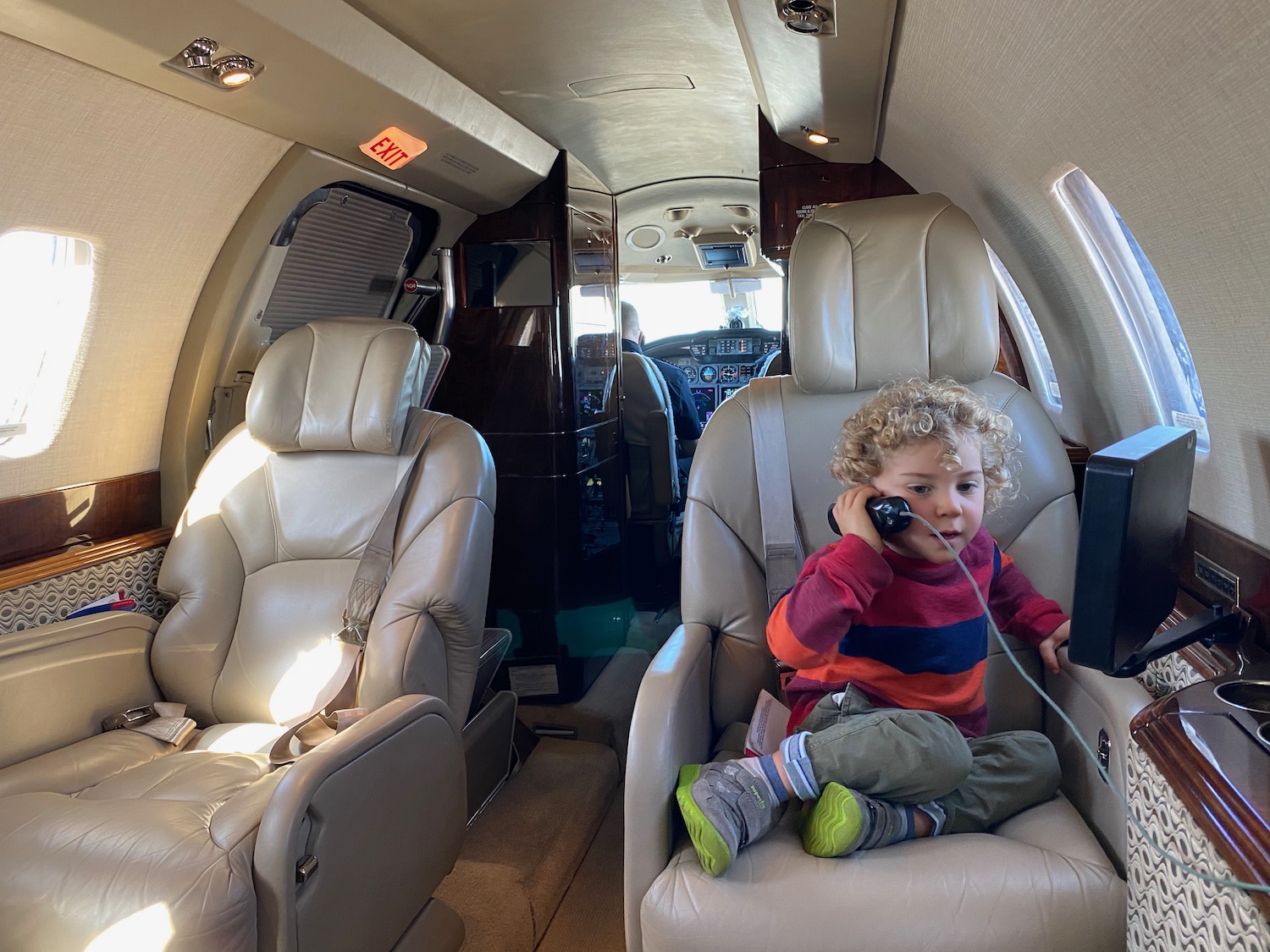 a child sitting in a chair in a plane