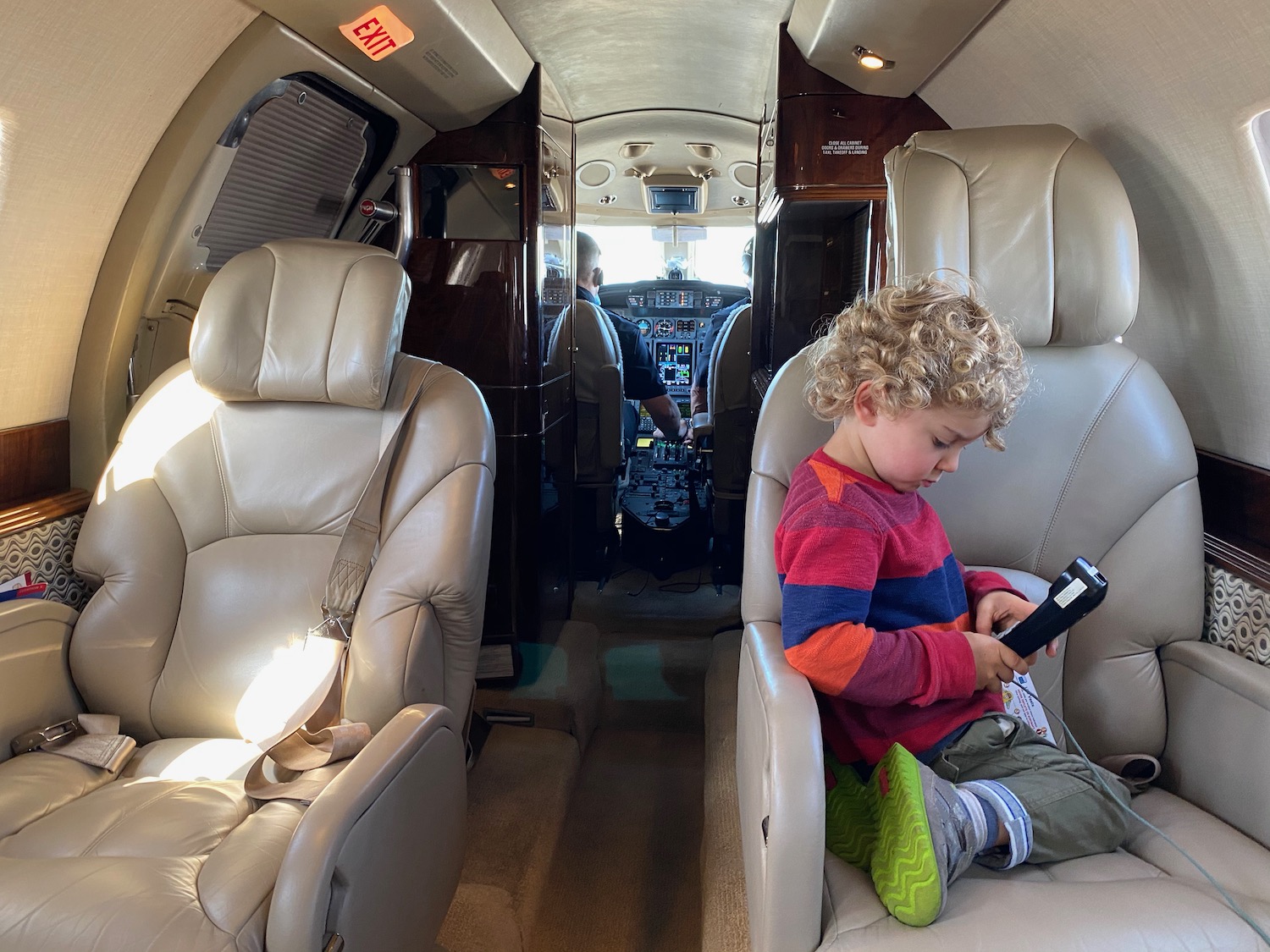 a child sitting in a chair in a plane