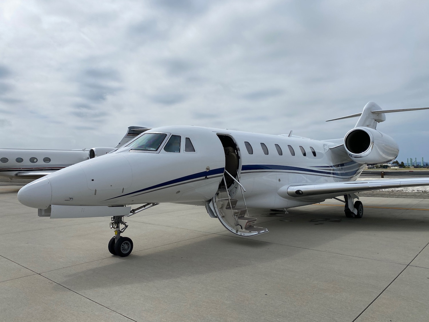 a white airplane with a door open