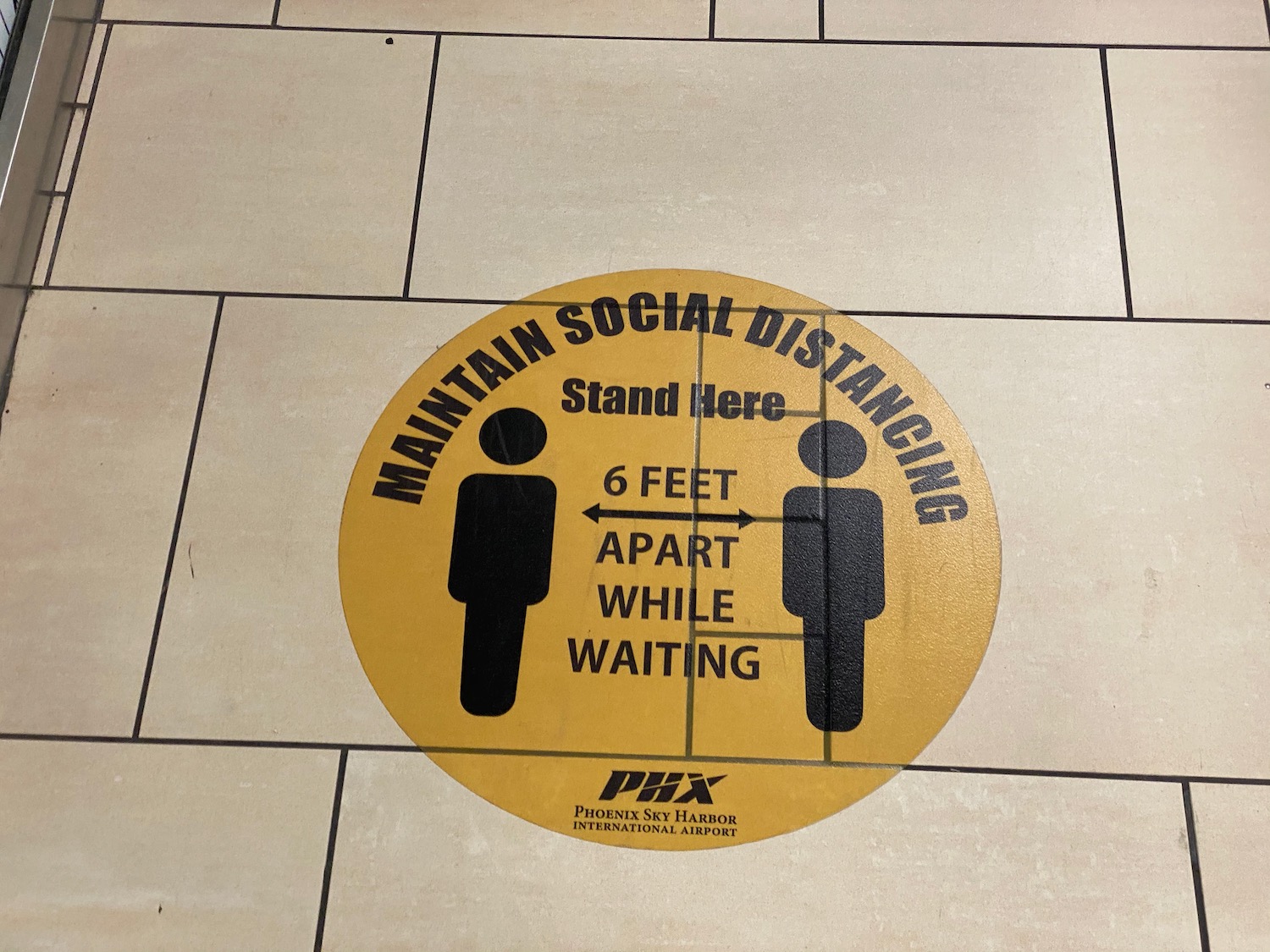 a yellow sign on a tile floor