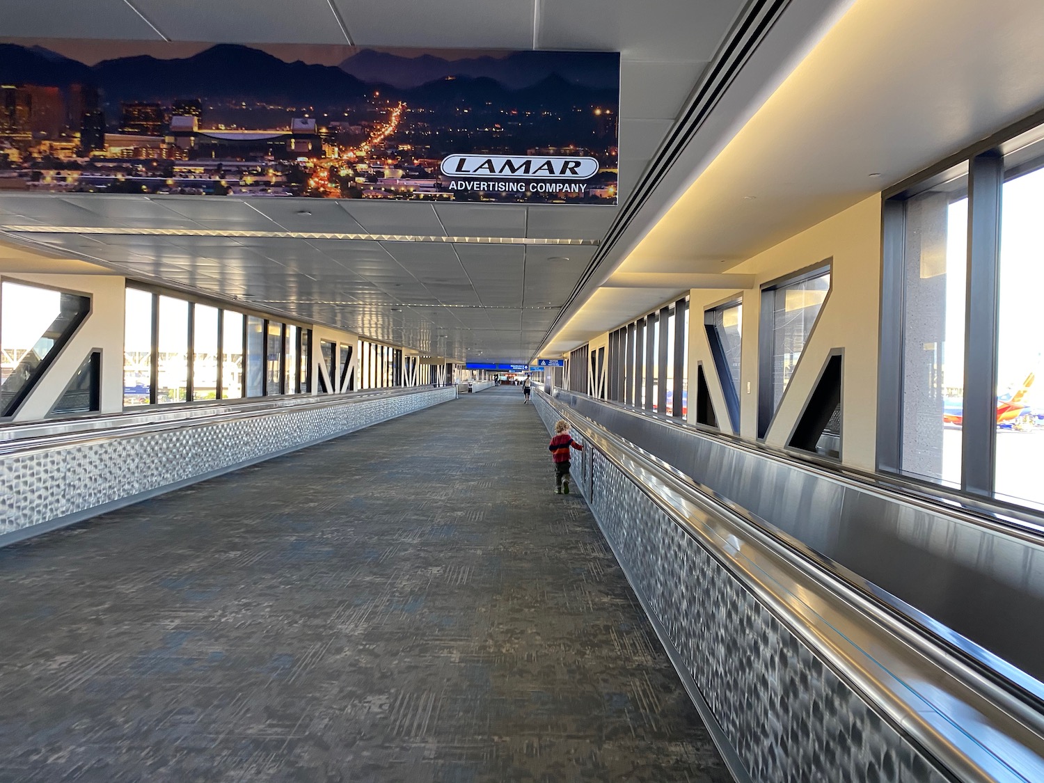 a child standing on an escalator