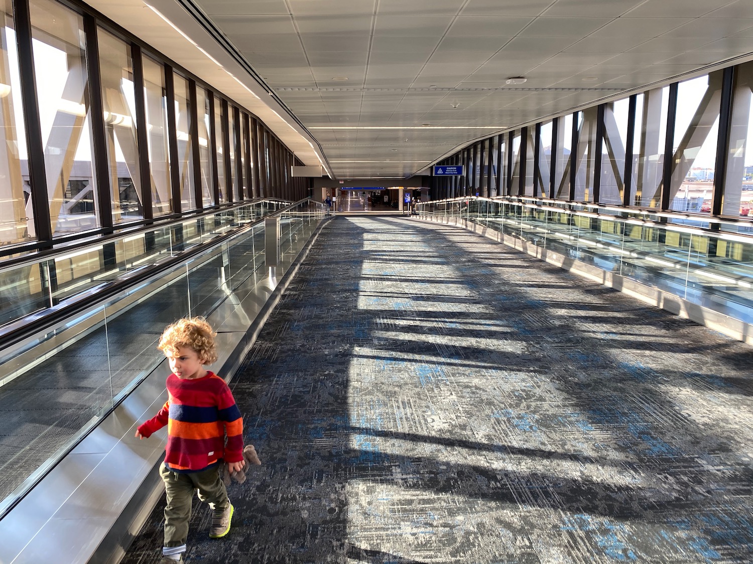 a child walking on an escalator