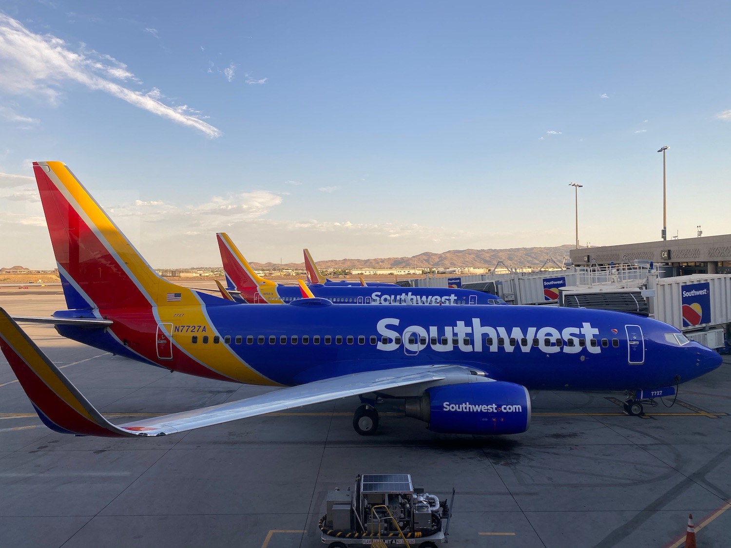 a group of airplanes parked at an airport