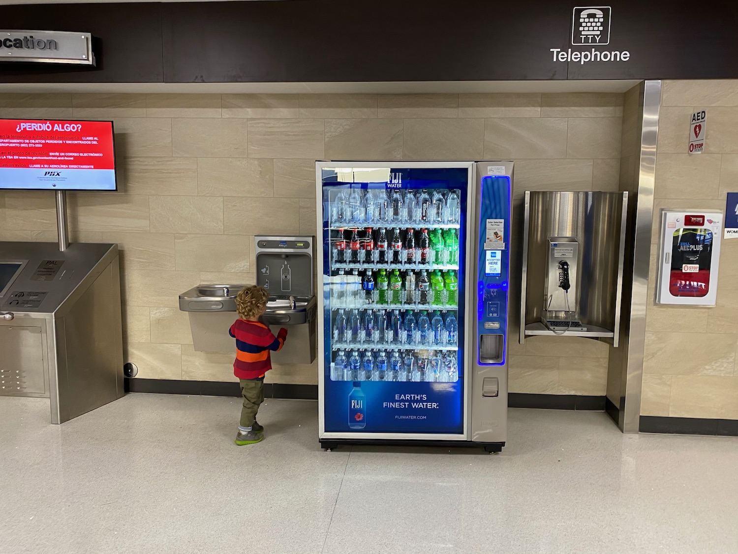 a child standing by a machine