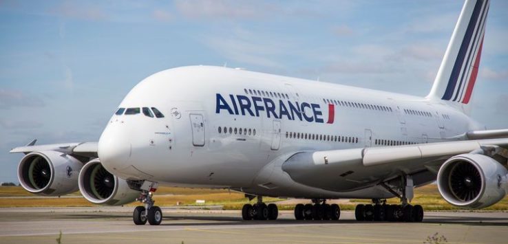 a large white airplane on a runway