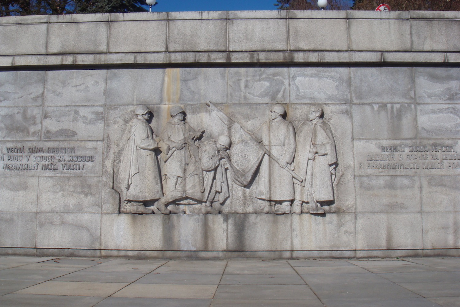 a stone wall with a group of people in robes