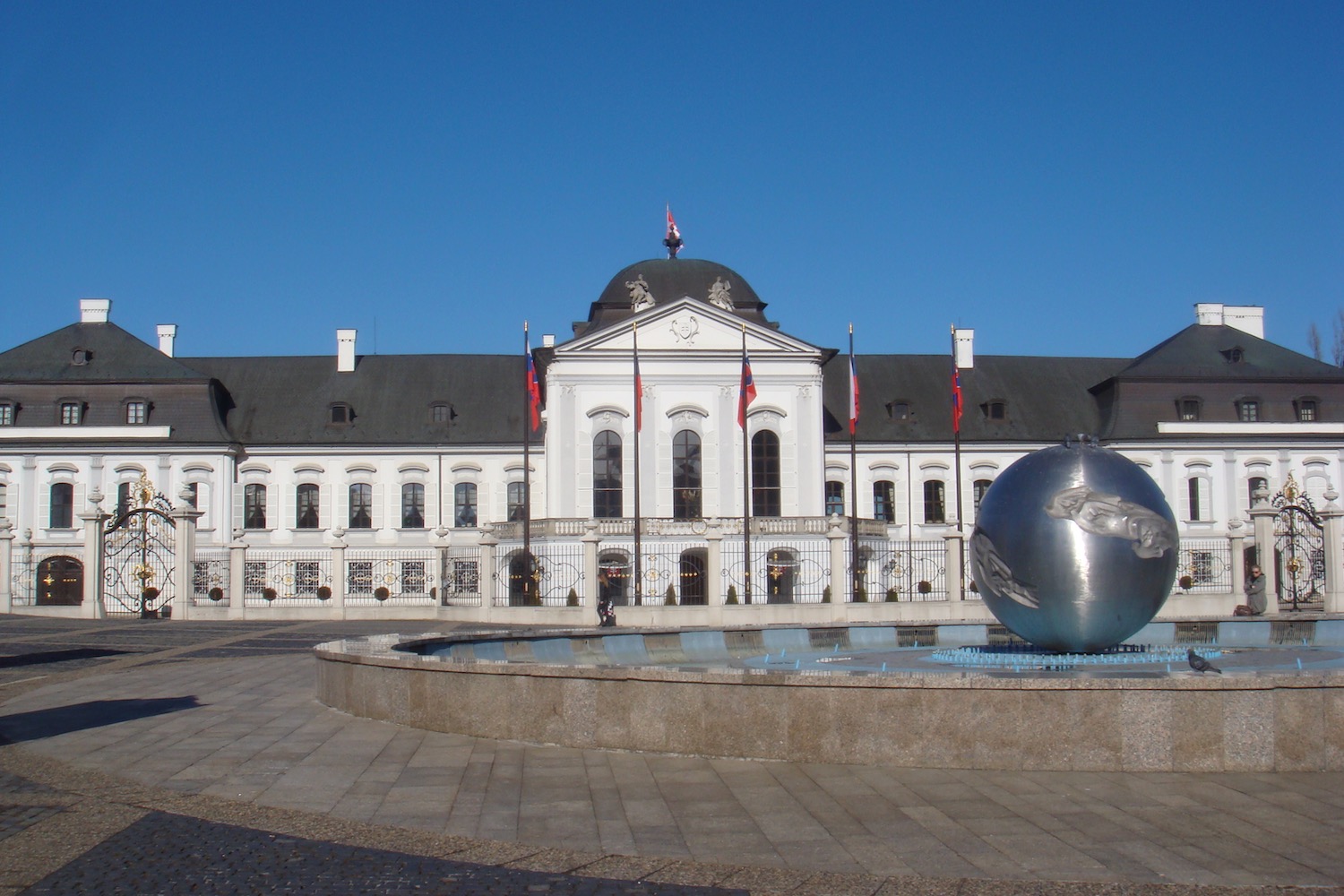 Grassalkovich Palace with a fountain and a large ball in front of it