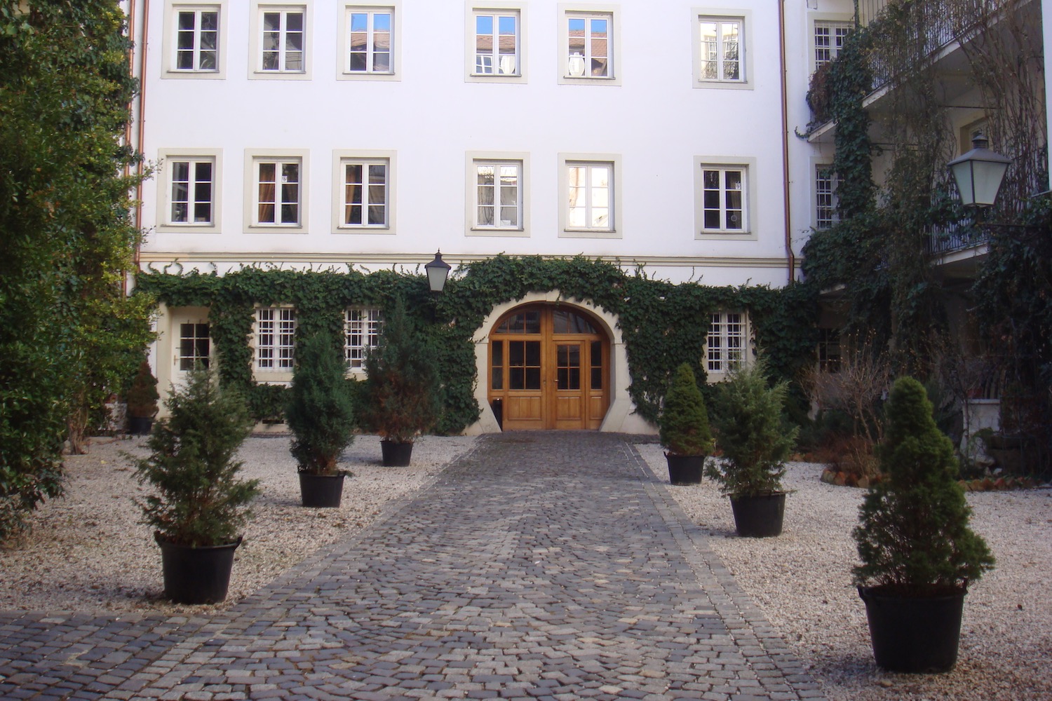 a building with a stone path and trees