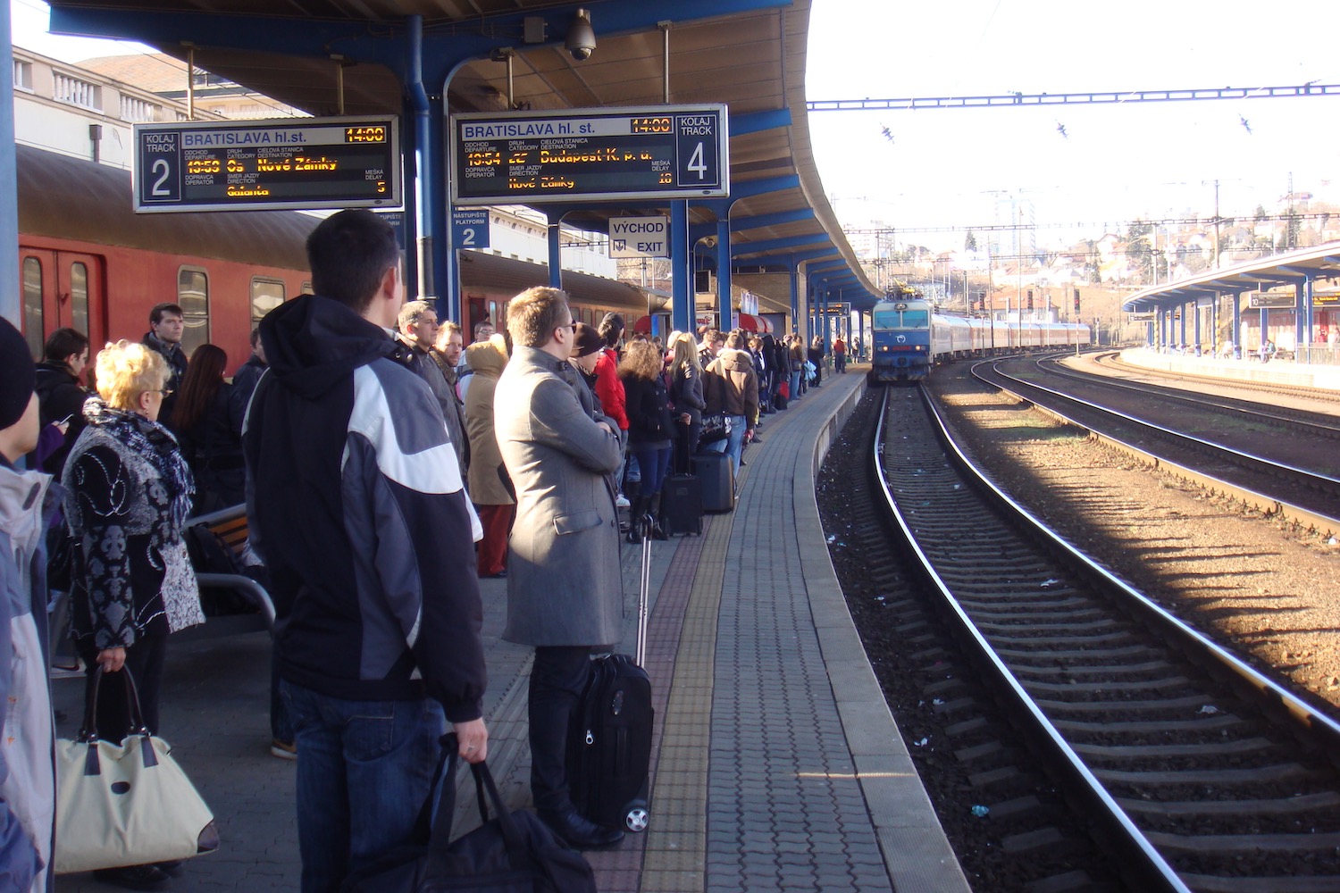 a group of people waiting at a train station