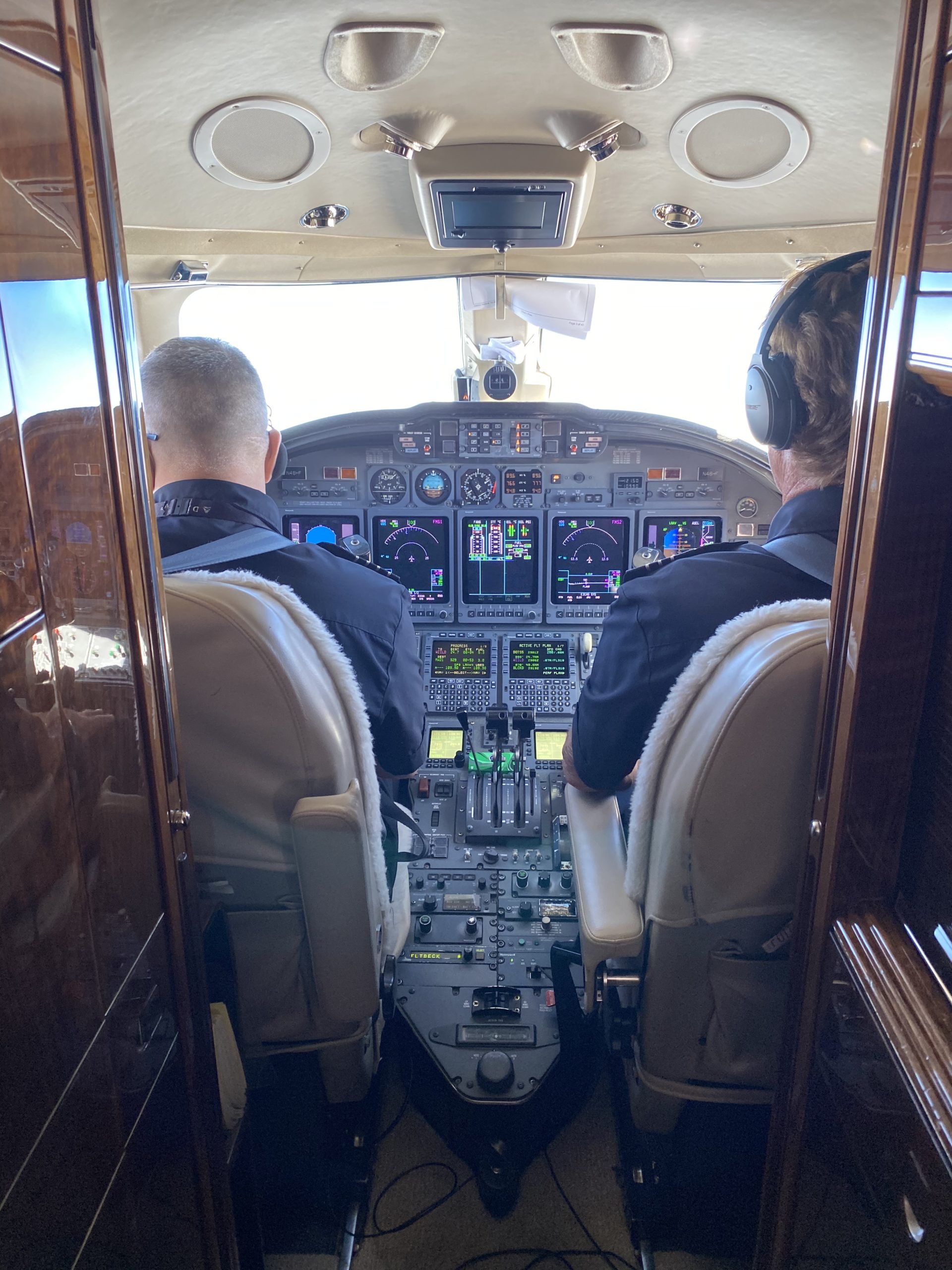 two men in the cockpit of an airplane