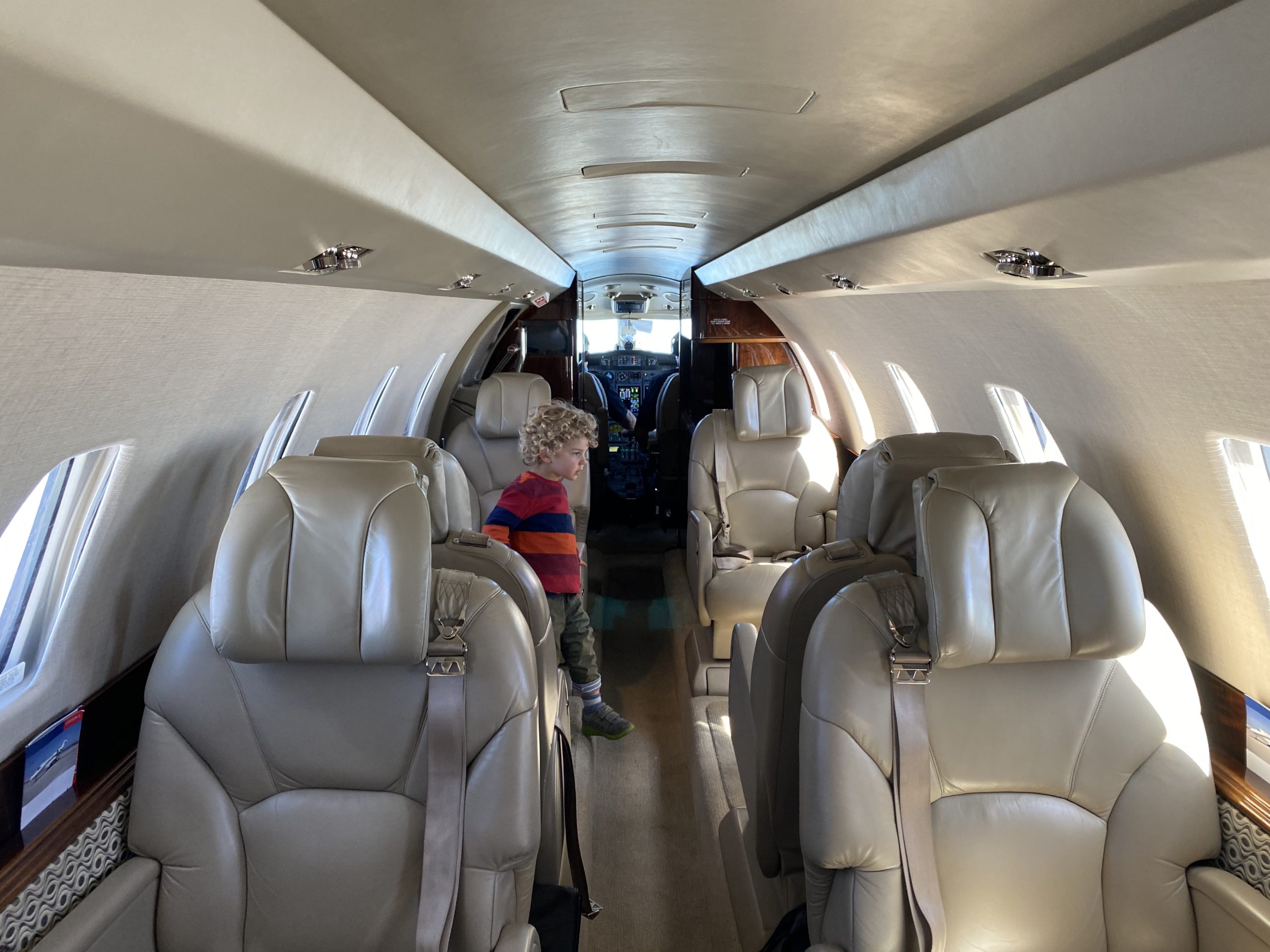 a child standing in the back of an airplane