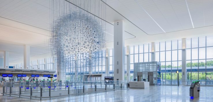 a large white building with glass walls and a large white ceiling