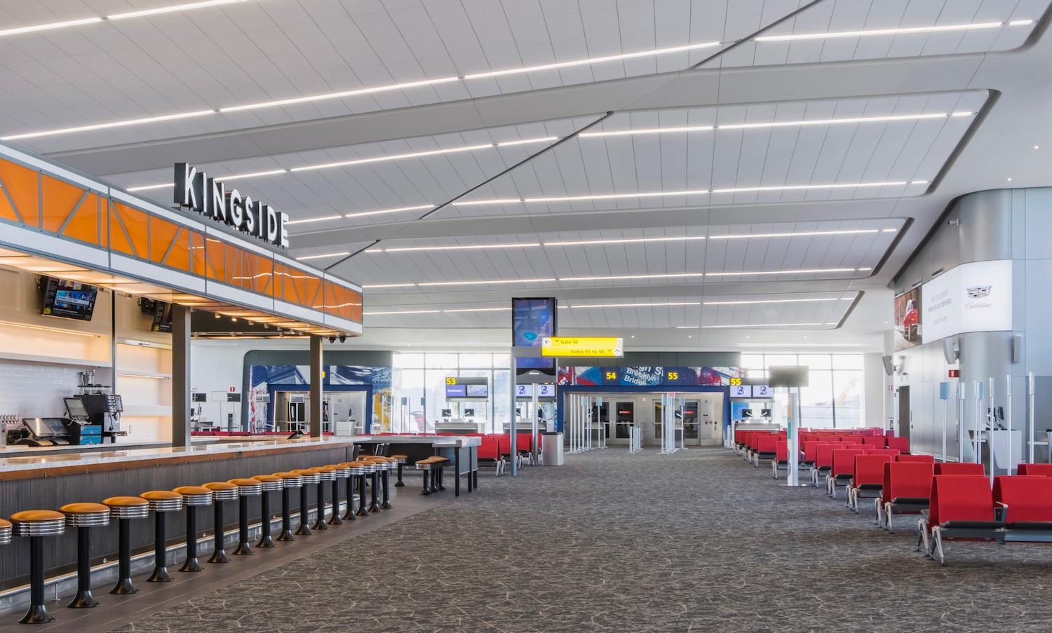 an airport terminal with tables and chairs