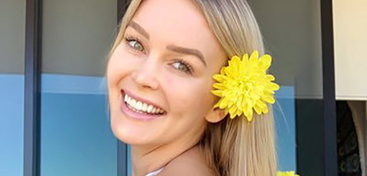 a woman with a yellow flower in her hair