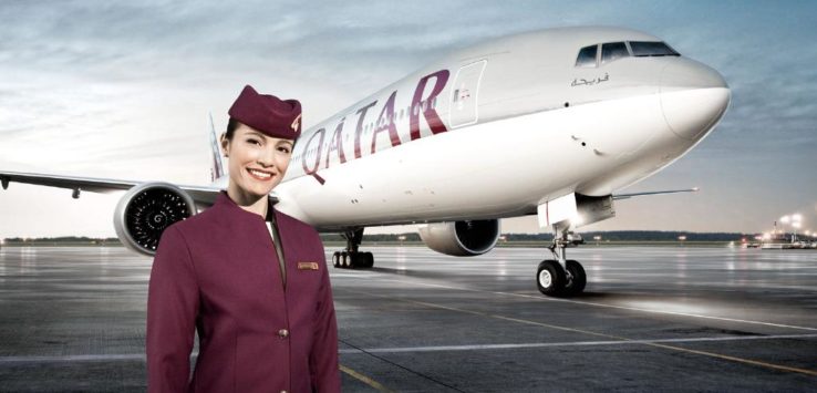 a woman in a uniform standing in front of a plane