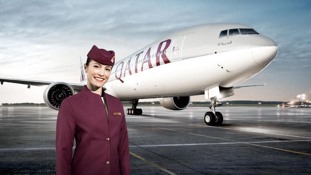 a woman in a uniform standing in front of a plane