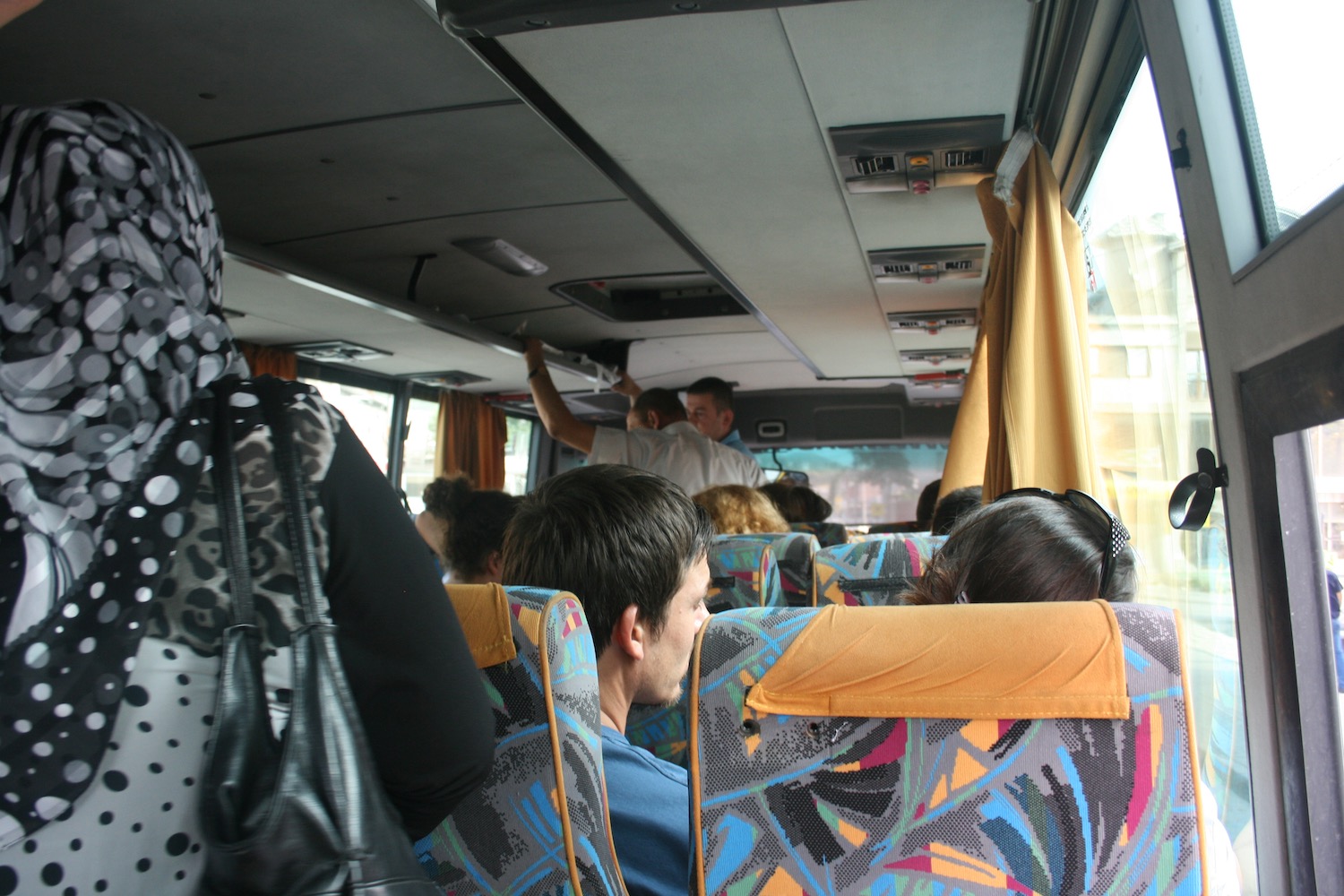 a group of people sitting on a bus