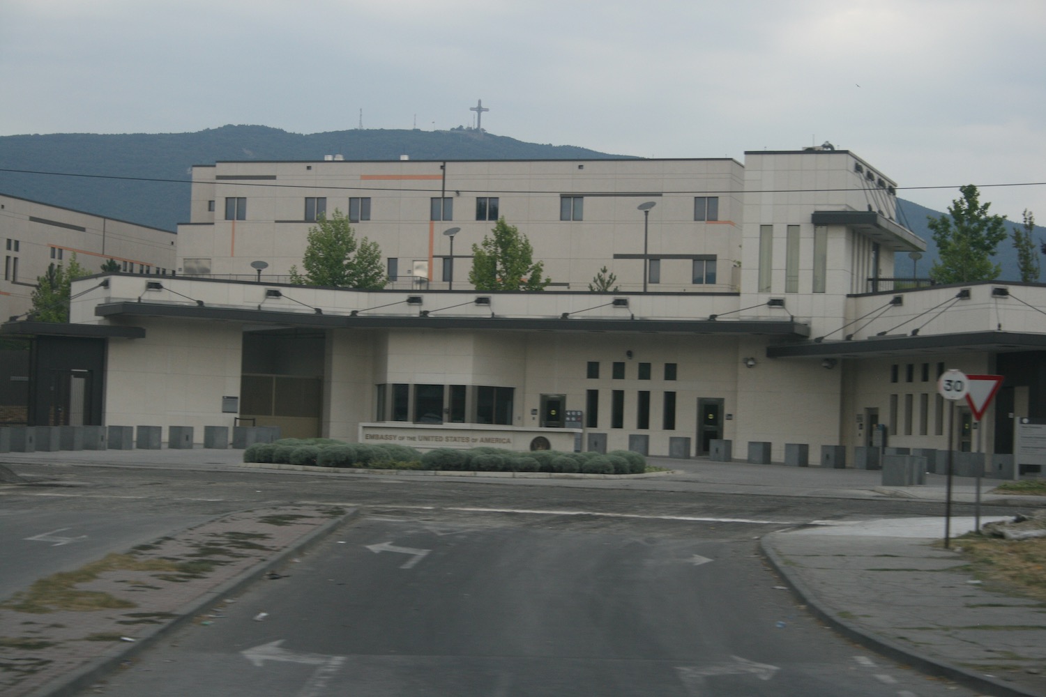 a building with a cross on the hill