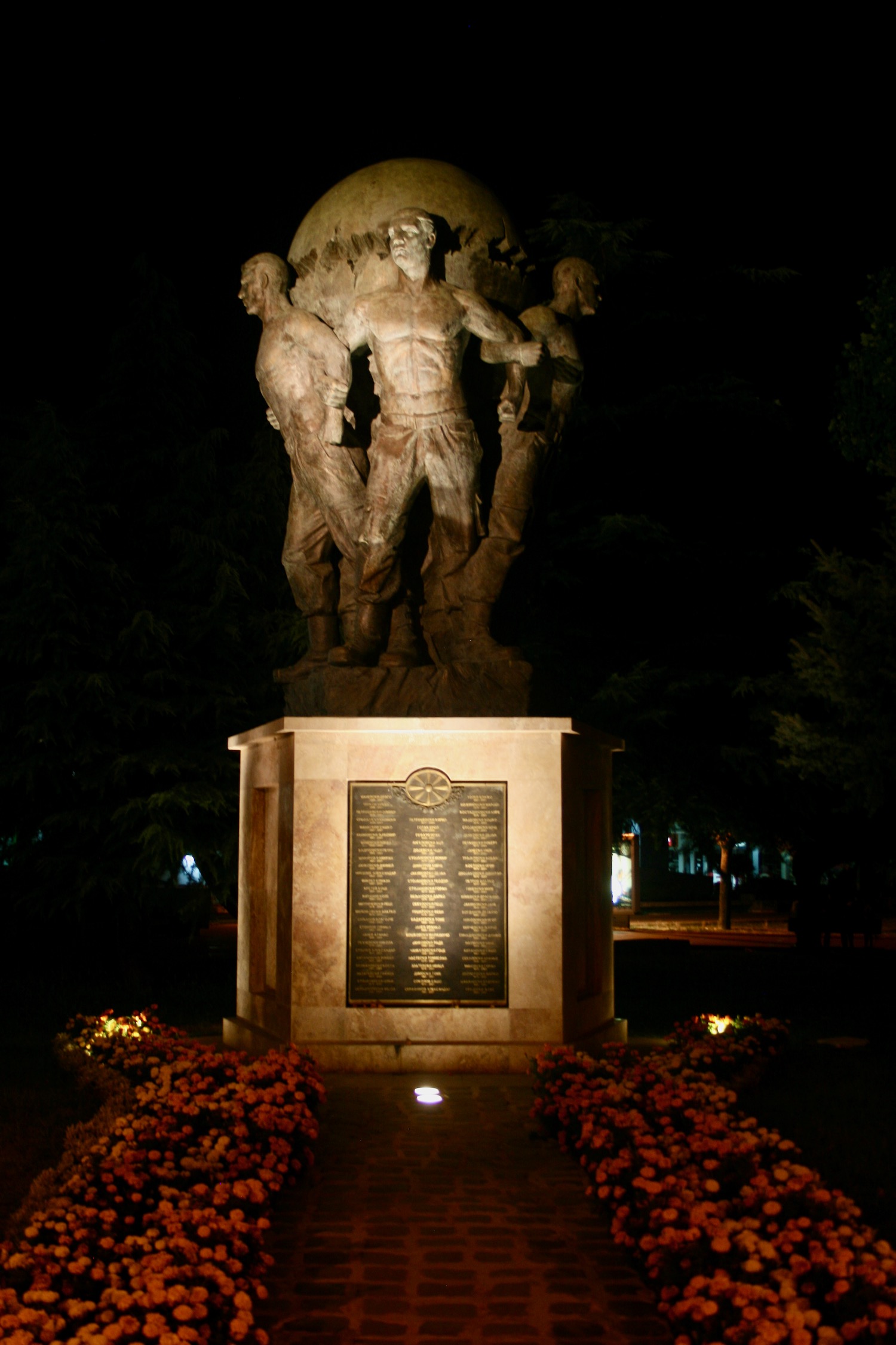 a statue of men holding hands