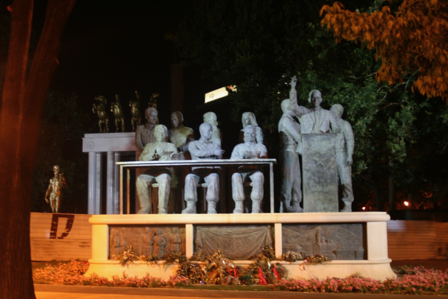 a statue of a group of people sitting at a table