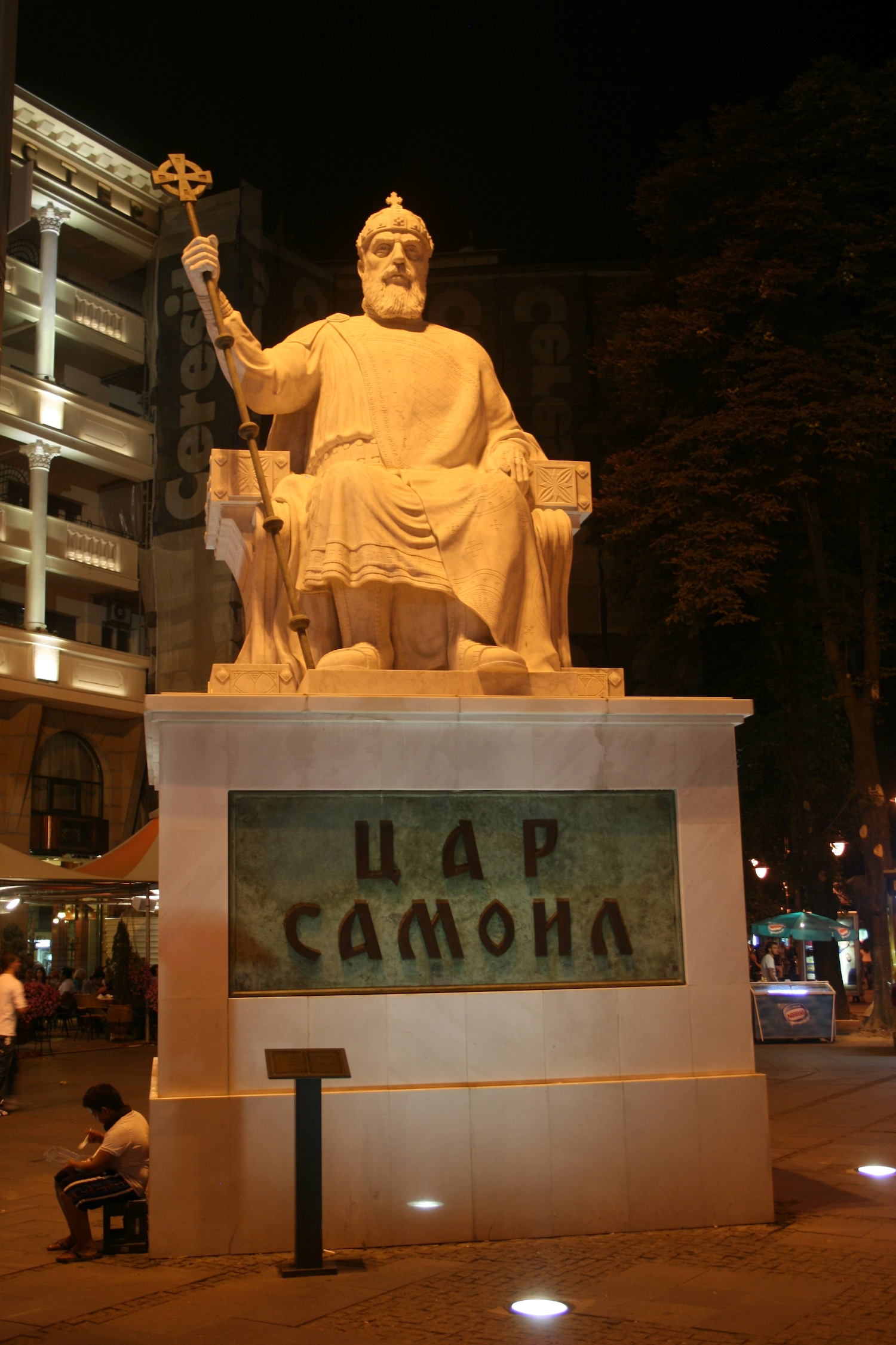 a statue of a man sitting on a chair