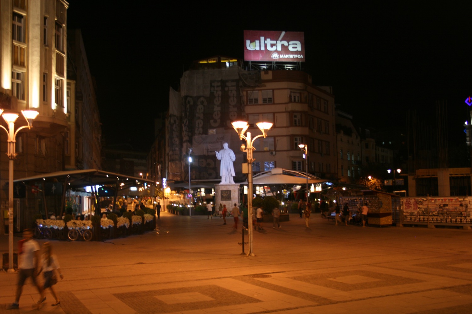 a statue in a city at night